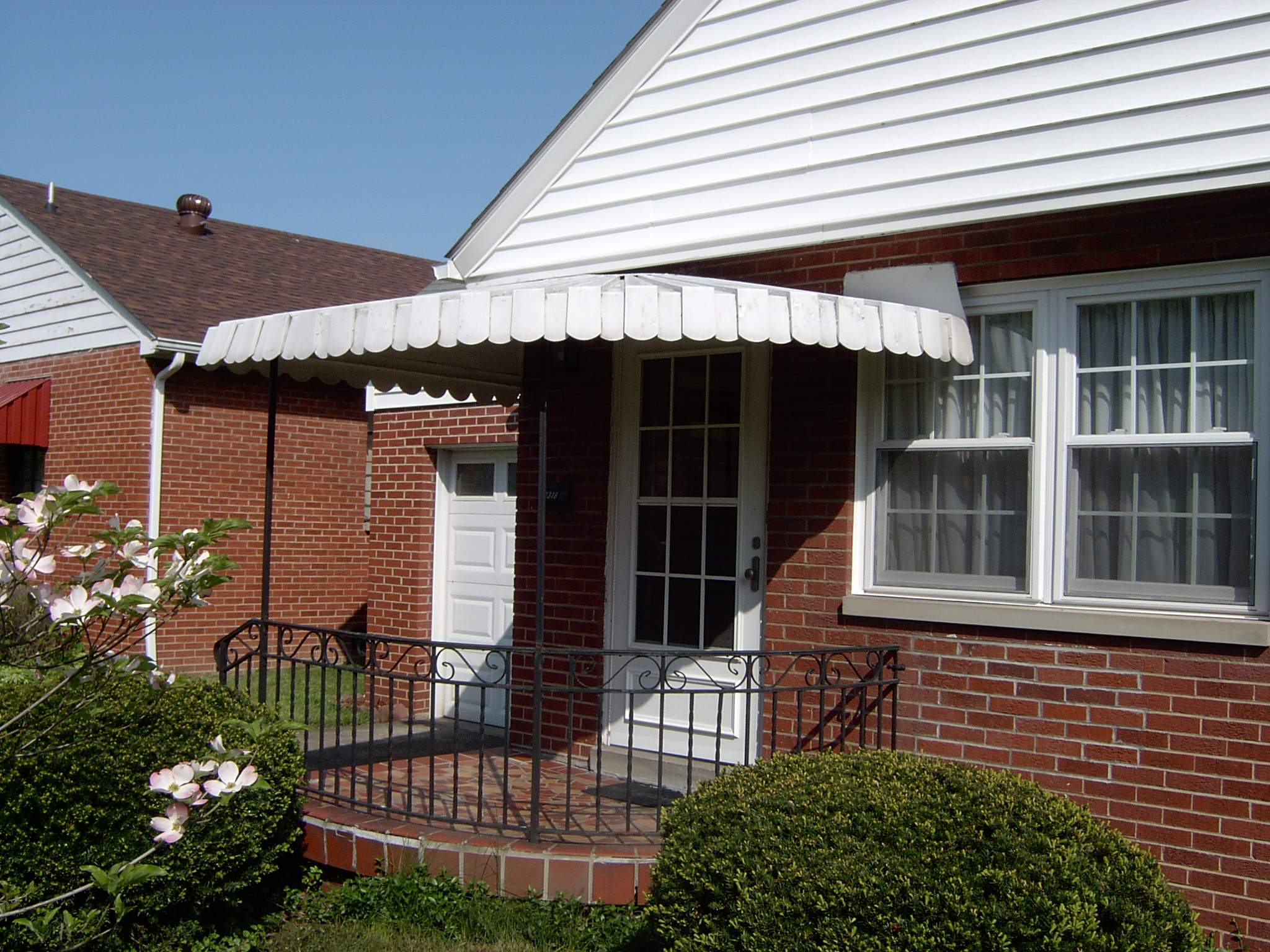 New front porch build, with tile floor and vinyl railing. by Secure Construction Company Inc