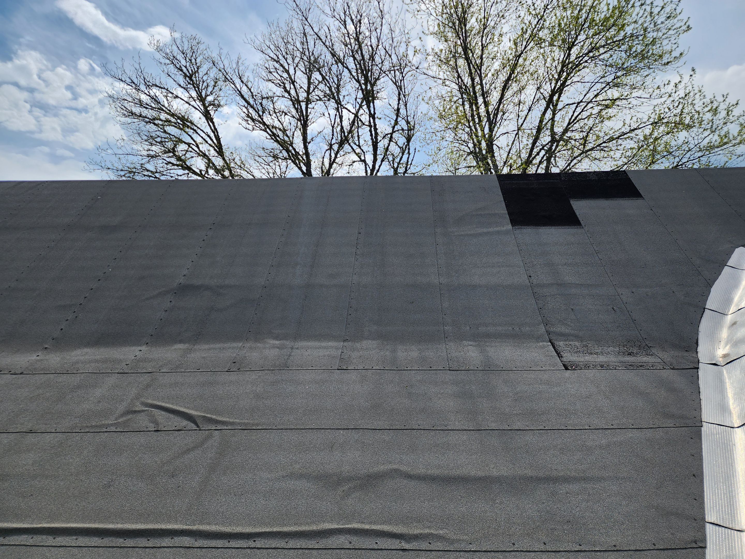 Residential Roofing Installation using 26 Gauge Colored Panels by Hostetler Roofing