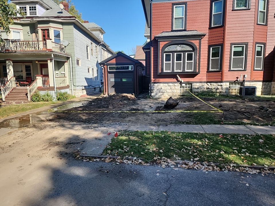 Exterior Renovations- Siding, Stamped Concrete, Porch, and Railings by Ivy Lea Construction