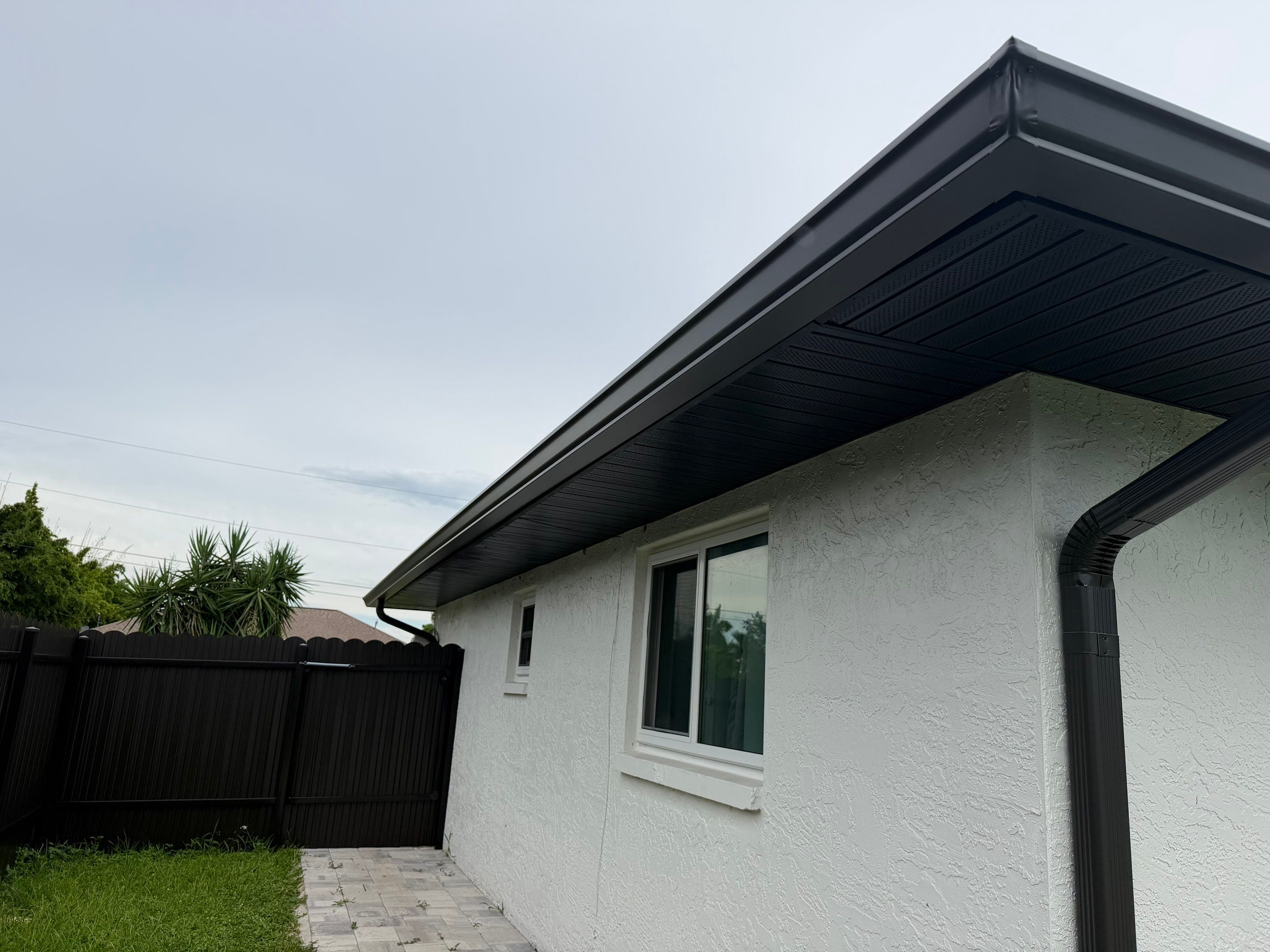 Black Seamless Gutters for a Modern Look in Cape Coral FL by Gutter Professors