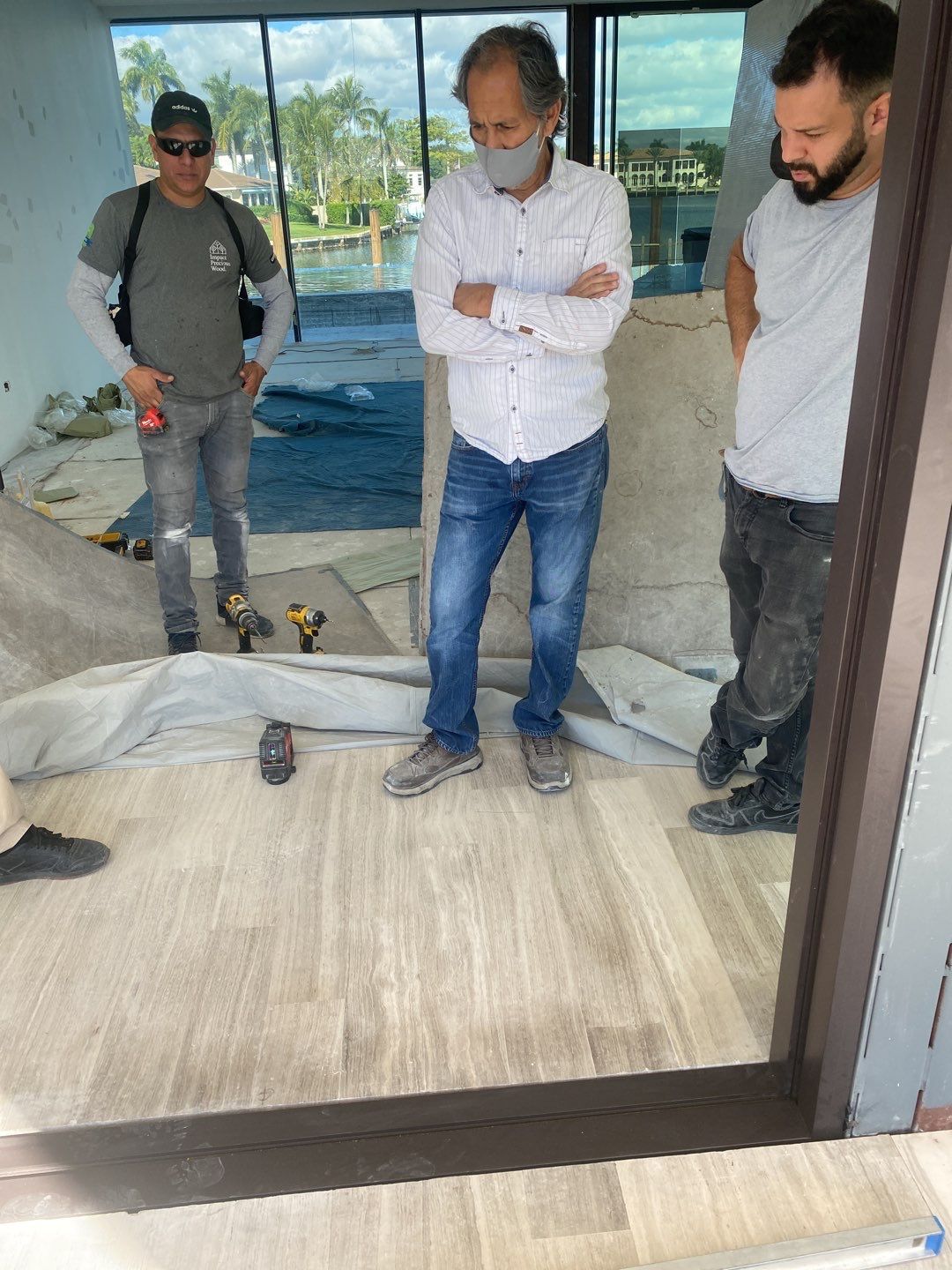 Custom Material Pivot Door installation by Impact Precious Wood Inc.