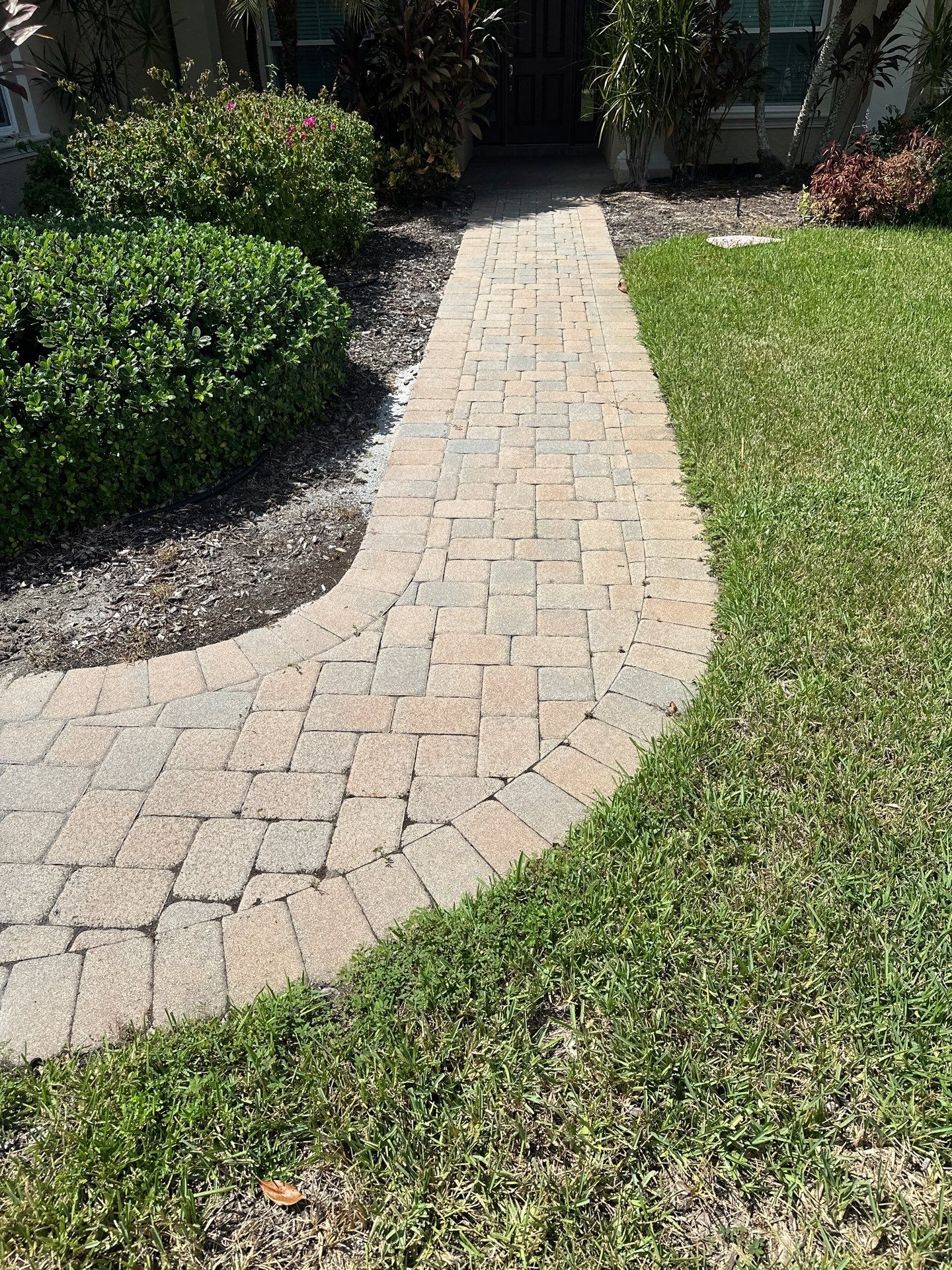 Paver Driveway, Entryway, Sidewalk, and Street Curbing Cleaning in Winding River Community, Bradenton, FL by Sunshine AquaWash