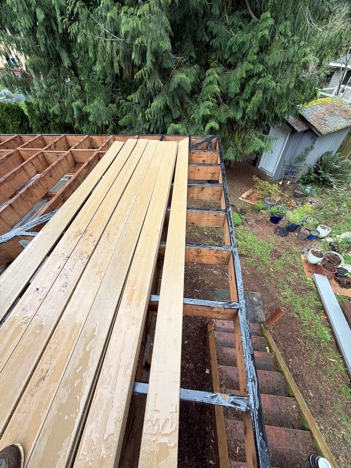 Elevated TimberTech Composite Deck Replacement With Black Metal Railings by Emerald City Energy