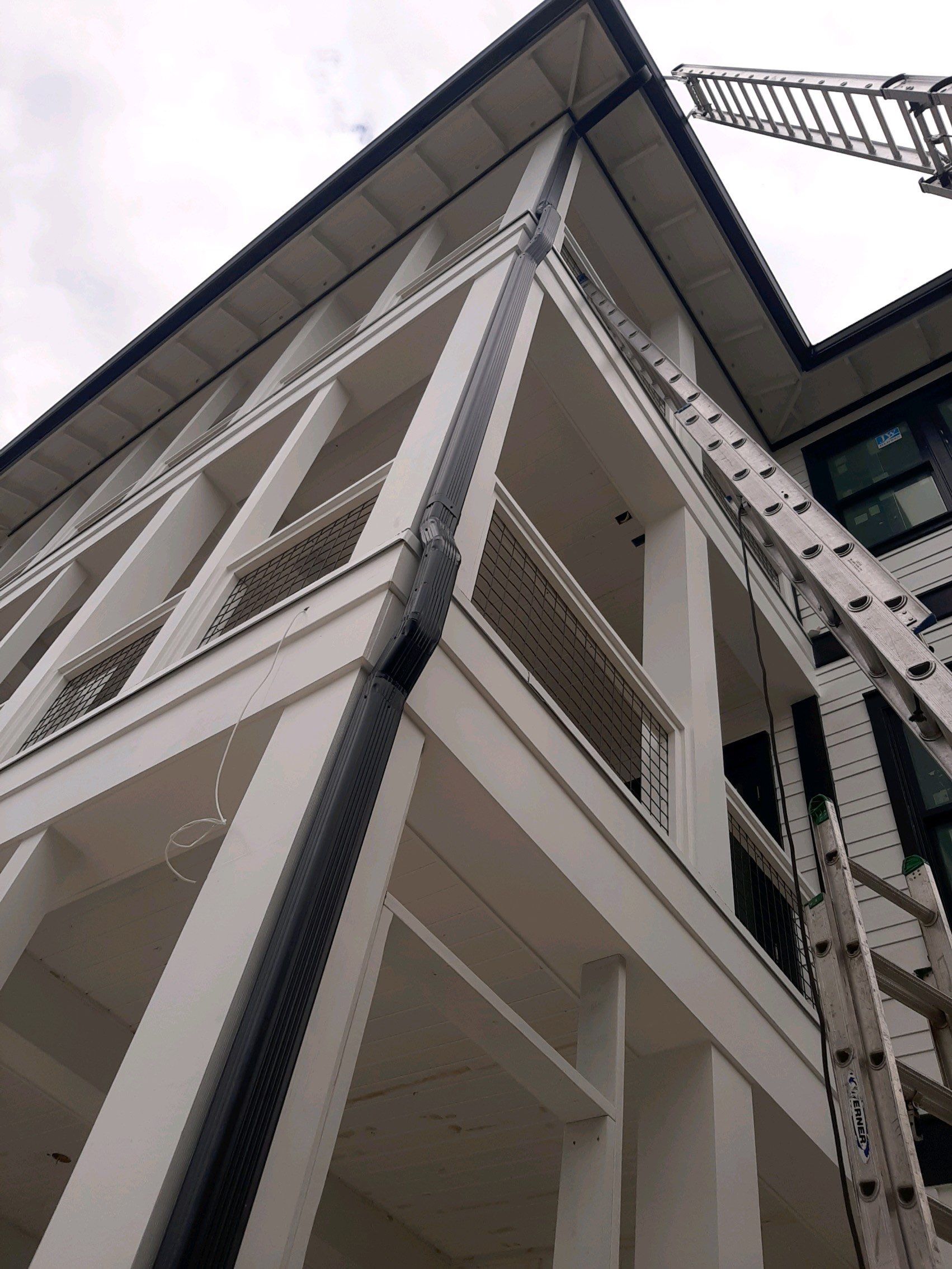 Seamless Gutter Installation Using Black Half Round Seamless Gutters by Gutter Professors