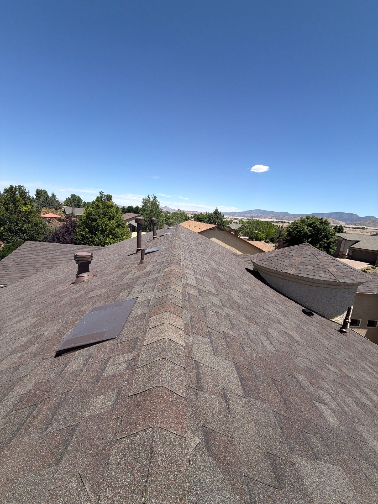 Residential Roofing Installation with Architectural Shingles and Turret Detail by Badger Roofing