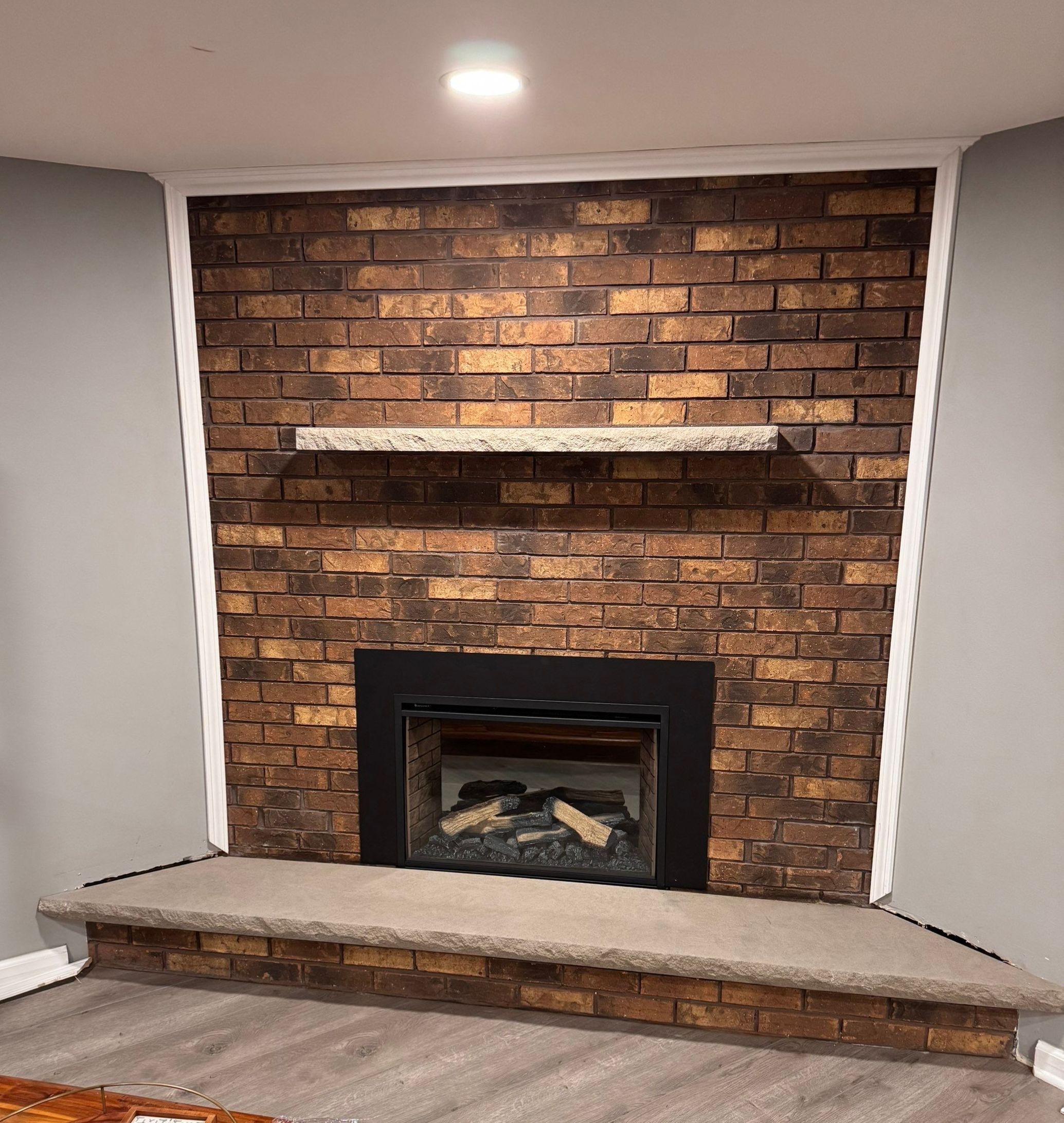 Electric Fireplace and Limestone Hearth & Mantel Installation by Leonard and Sons Building Services, Inc. 