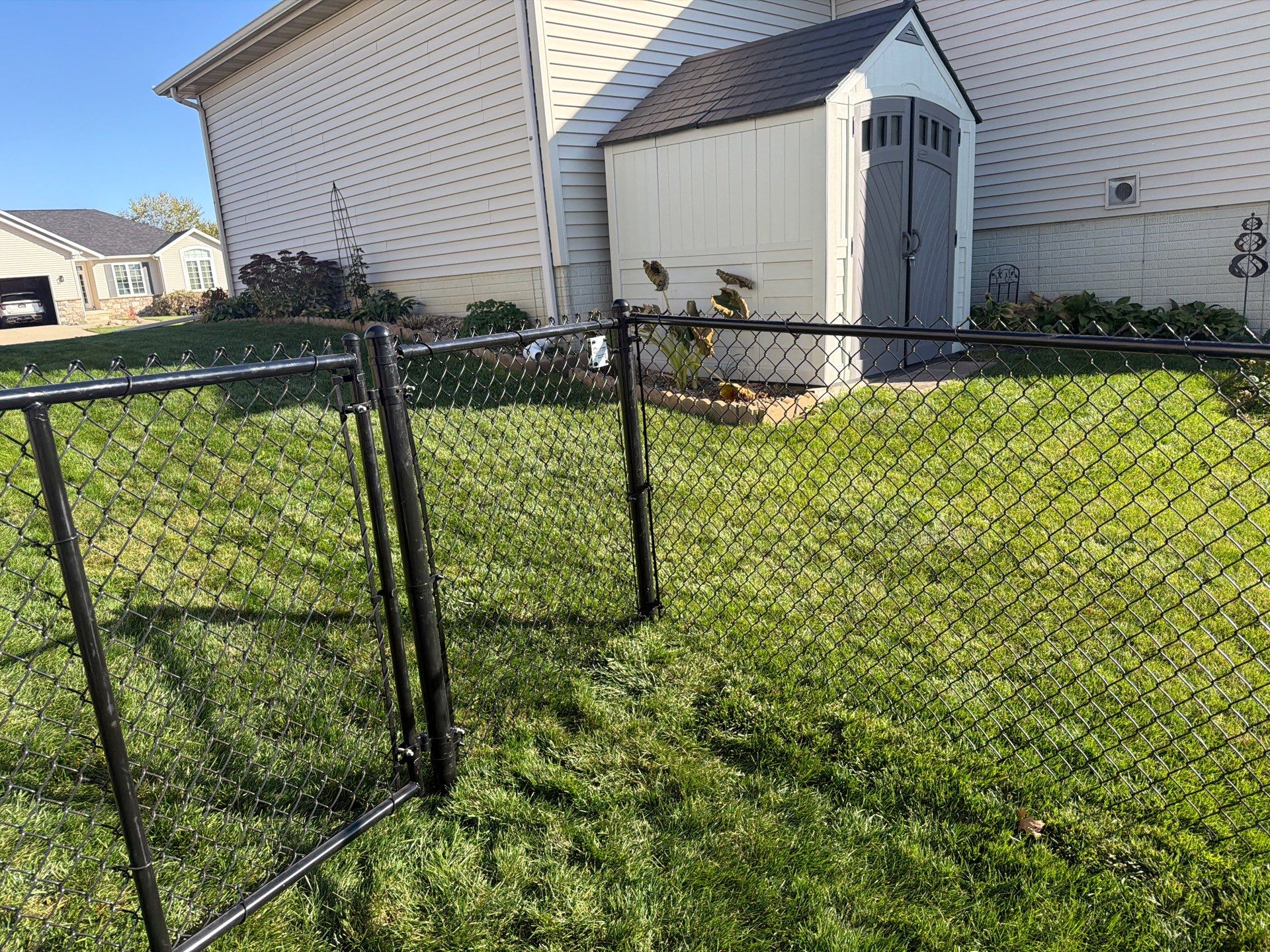 Black Vinyl-Coated Chain Link Fence Installation in Cedar Falls by Perfect Picket Fence and Stain