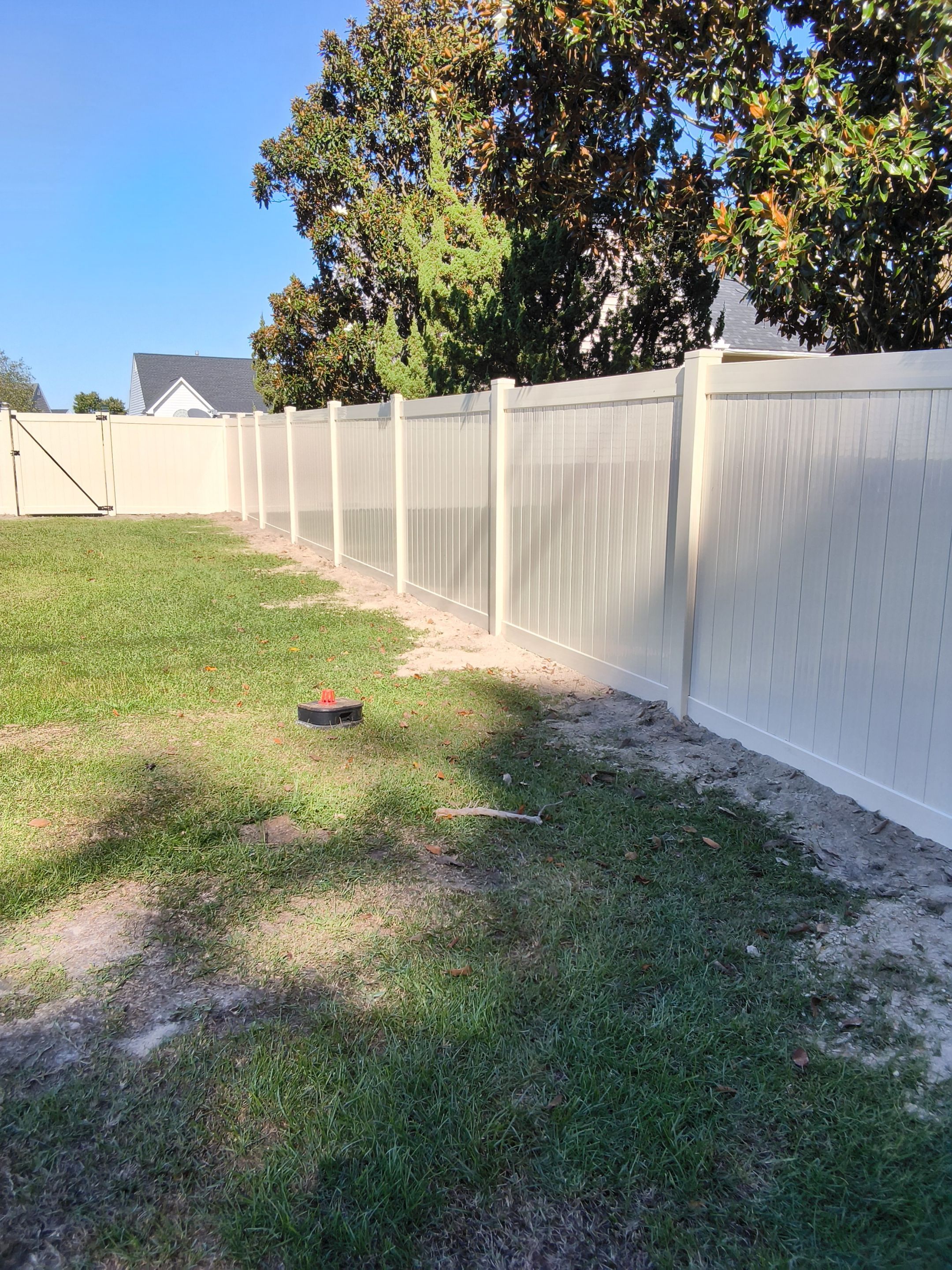 Custom Tan Vinyl Privacy Fence Installation with Double Gates in Winterville by Superior Fence and Rail