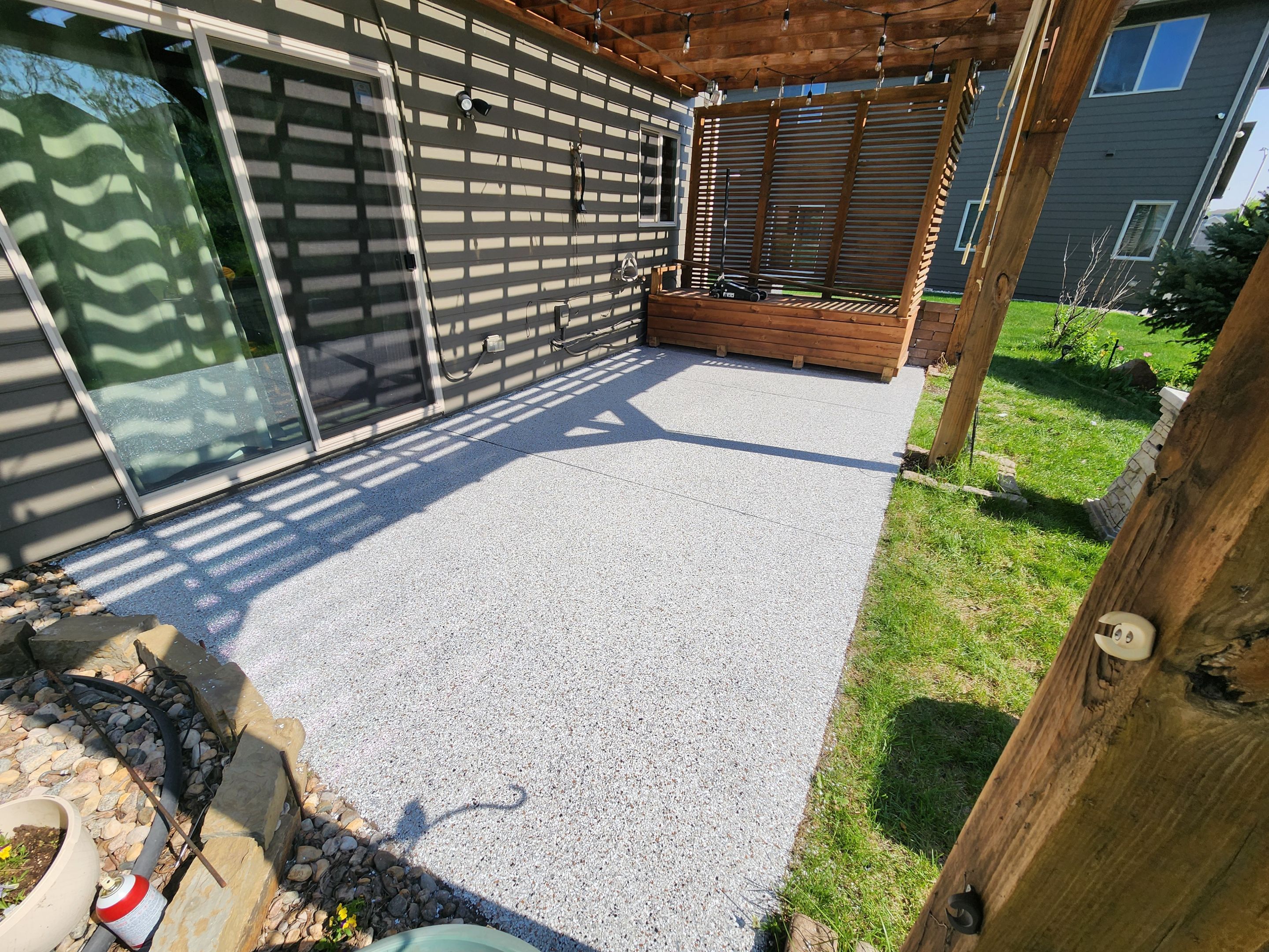 Coyote Flake Concrete Coating for Sioux Falls Patio by Select Painting, Coatings & Garage Cabinets