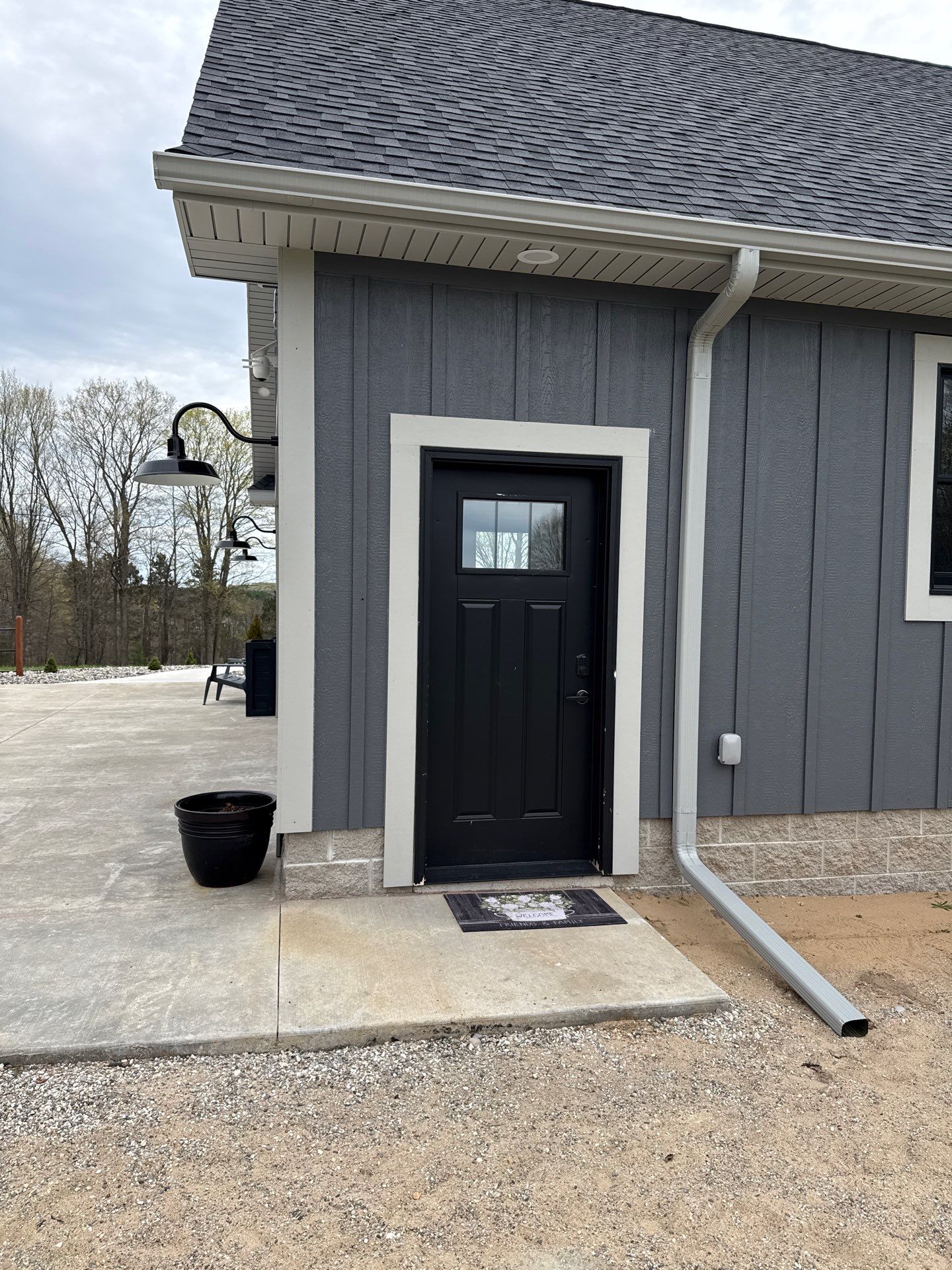 White Gutter and Downspout Installation on Modern Kingsley Residence by Rainbow Seamless Systems