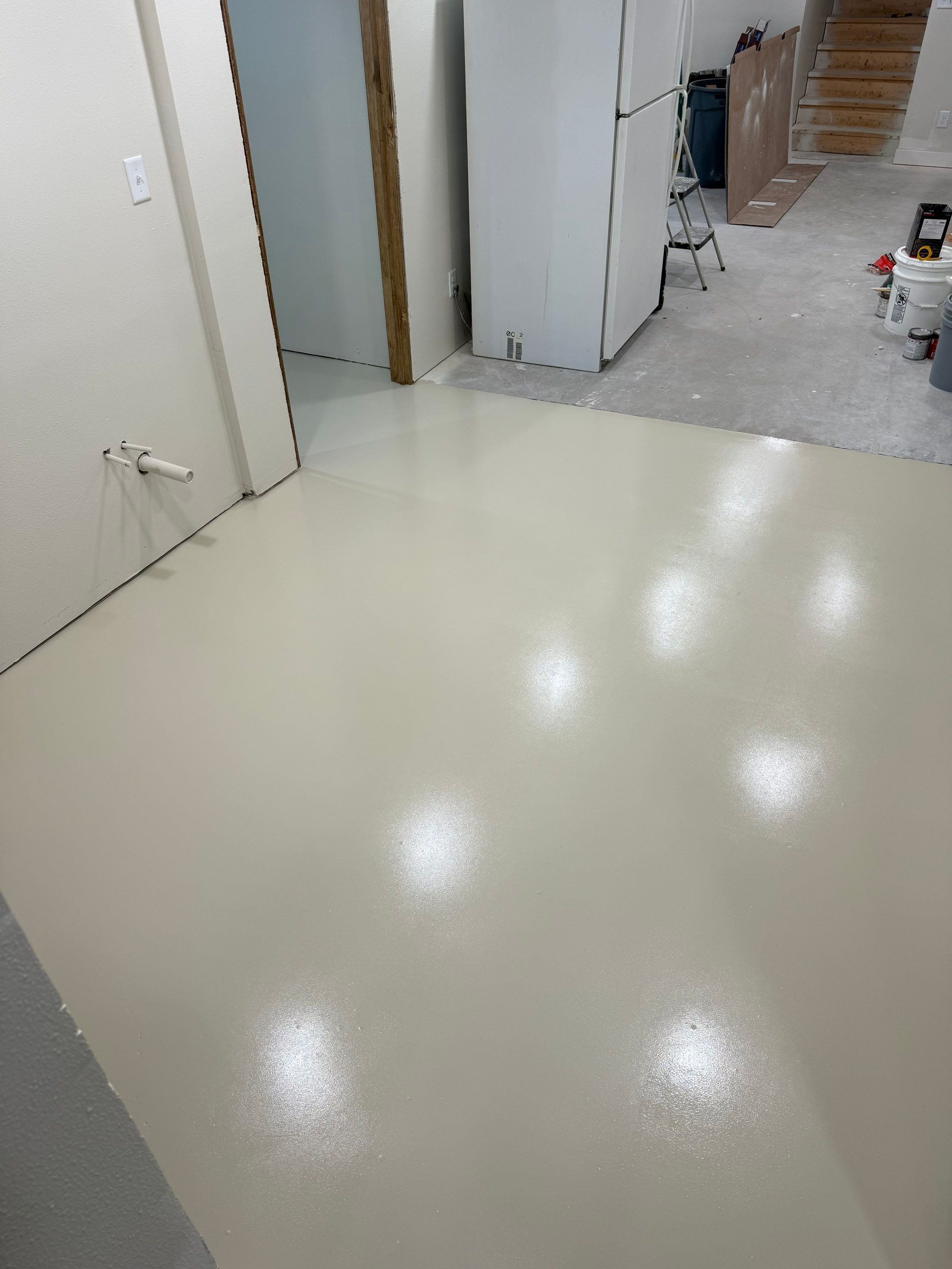 High-Gloss Epoxy Floor Coating and Basement Renovation in Rock Rapids by Select Painting, Coatings & Garage Cabinets
