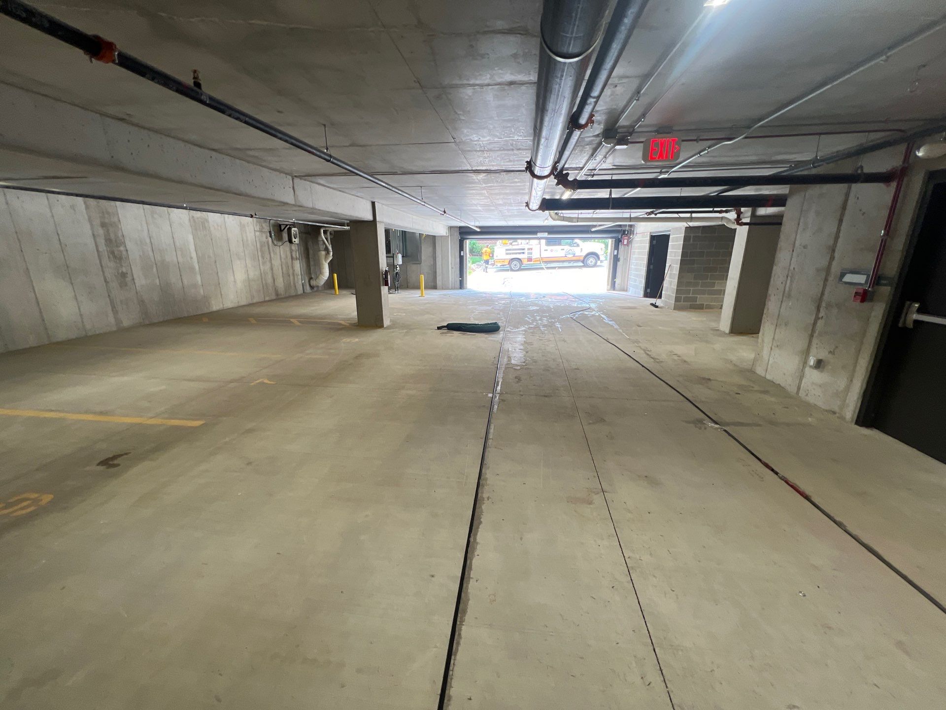 Parking garage using Hot water by Northern Power Washing LLC.