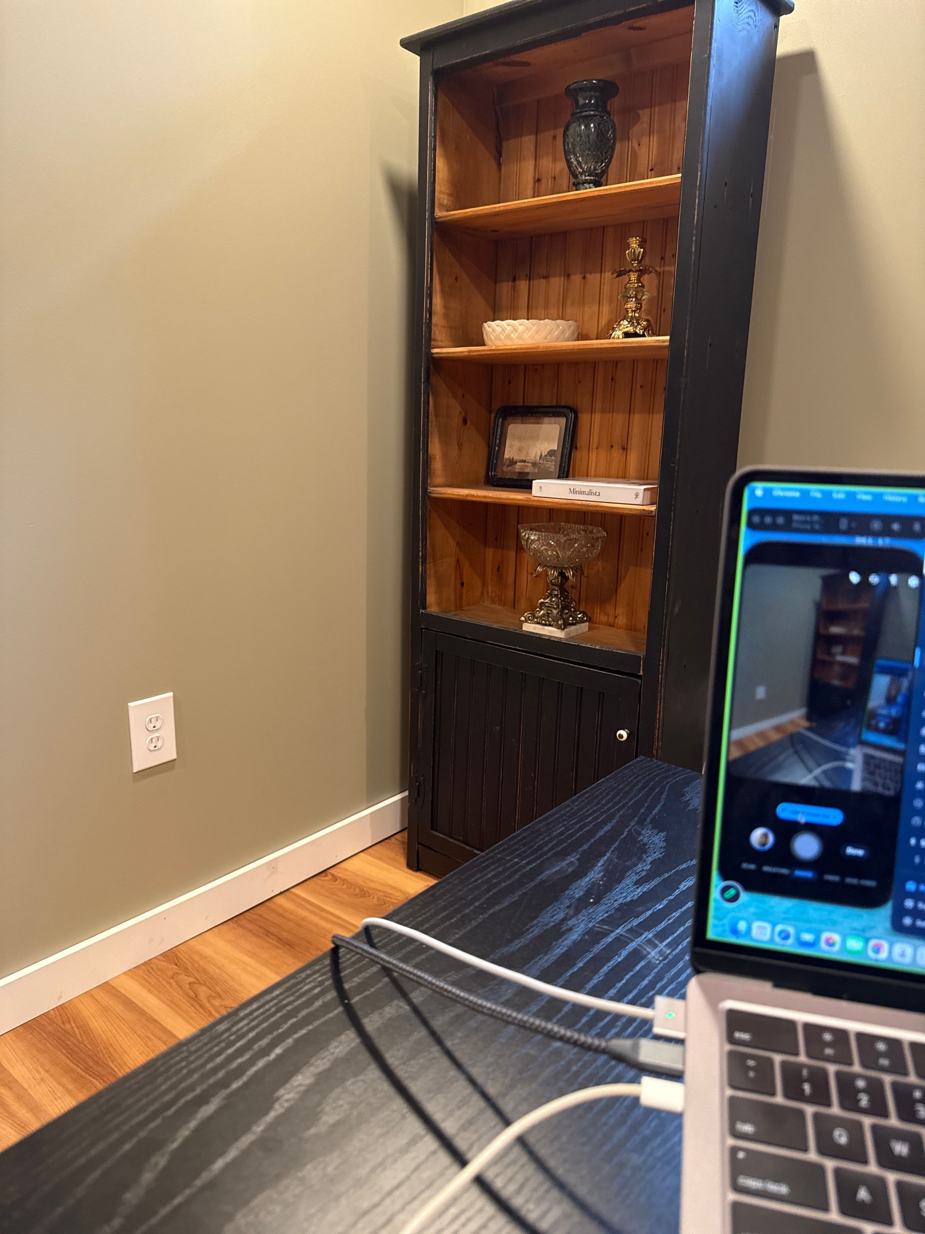 Home Office Setup with Sage Walls and Dark Wood Shelving by CompanyCam Sales Demo