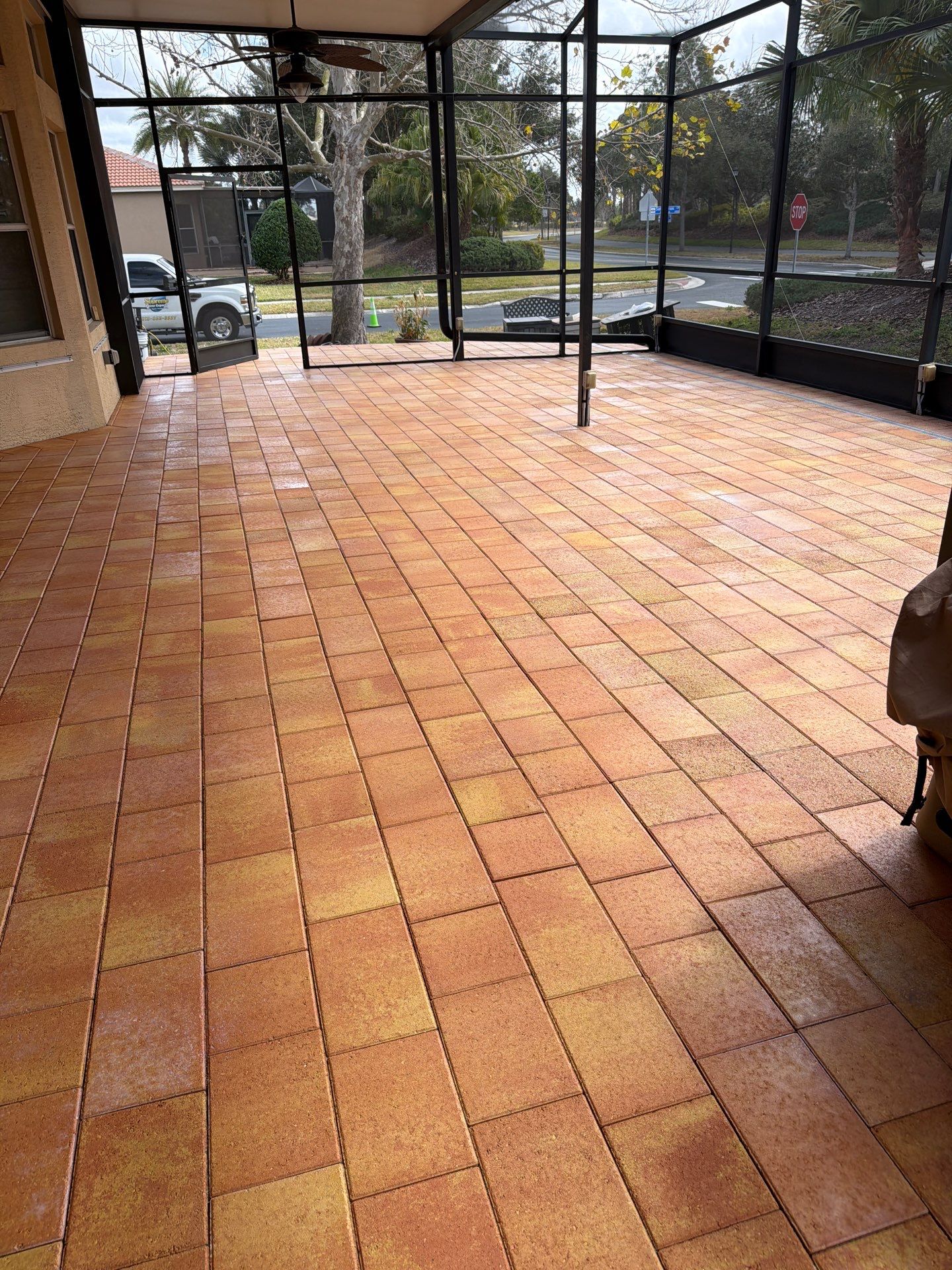 Paver Sealing for Herringbone Driveway and Screened Lanai in Valencia Lakes by Supreme Paver Experts