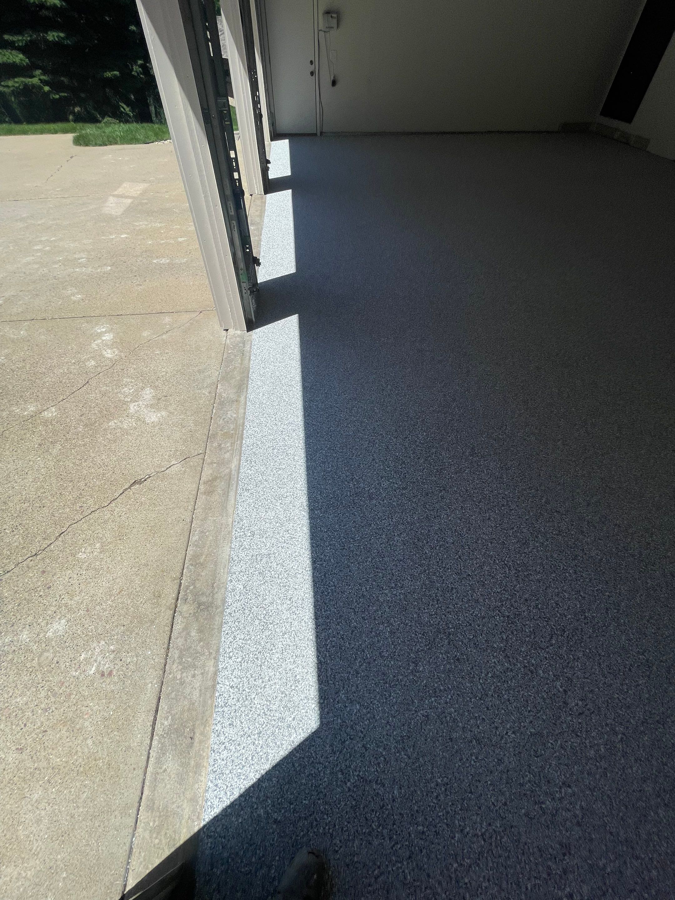 Gray Speckled Epoxy Garage Floor Coating in Sioux Falls by Select Painting, Coatings & Garage Cabinets
