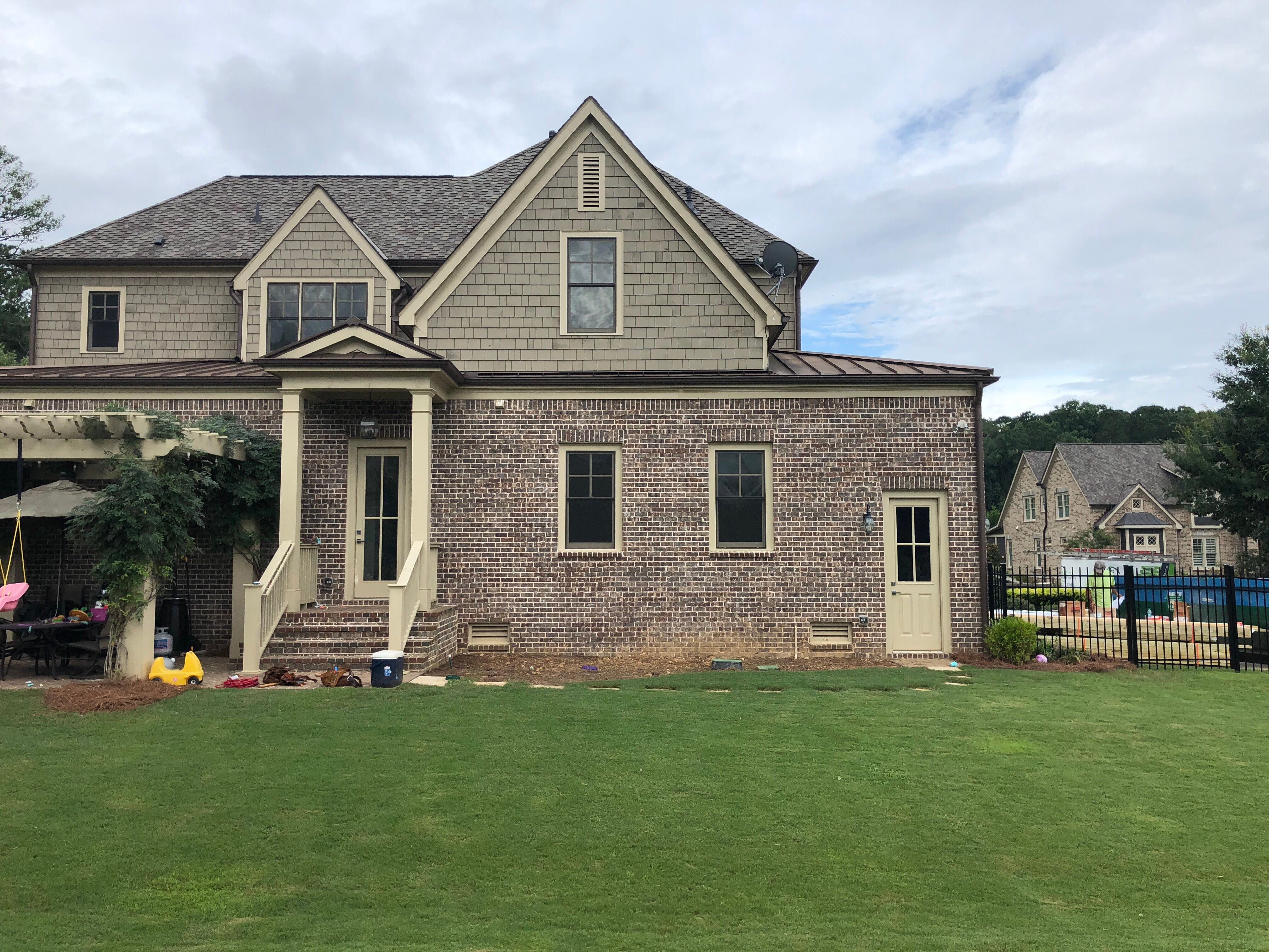 Custom Screened Porch Addition with White Brick Fireplace in Duluth by Swift Home Renovations