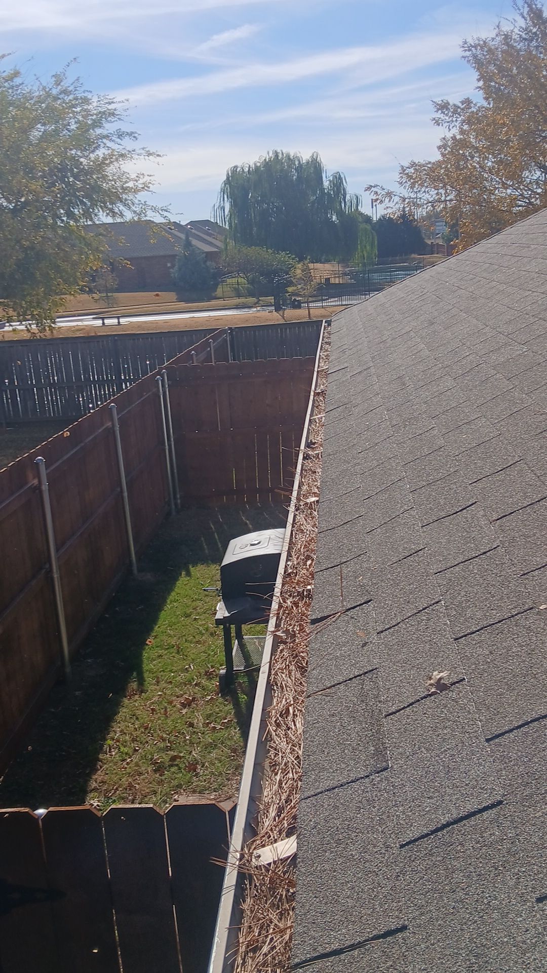 Commercial gutter cleaning Oklahoma City before photo with filled gutters