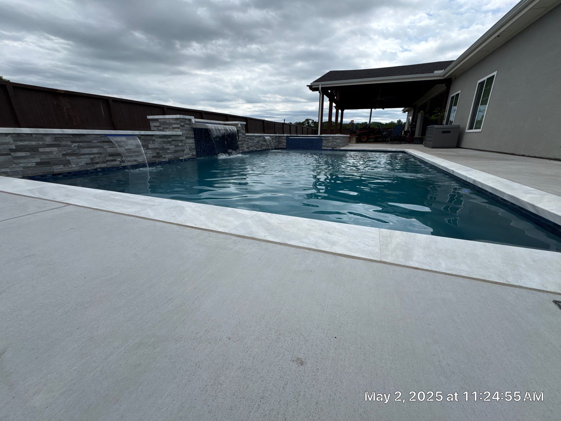 Geometric Pool and Spa with Stone Water Feature Wall by Pinnacle Pools and Spas - DFW