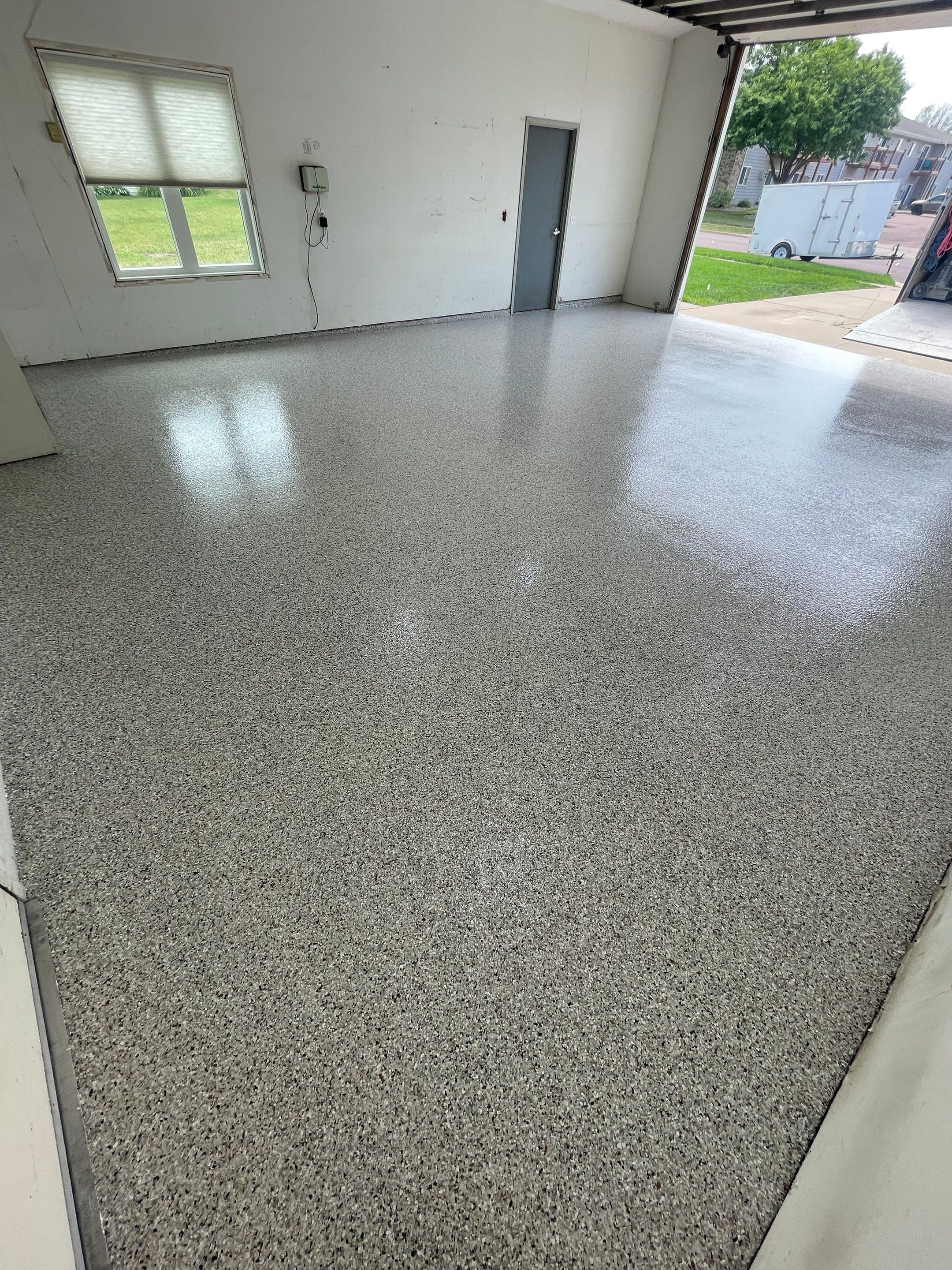 Coyote Flake Concrete Coating for Sioux Falls Garage by Select Painting, Coatings & Garage Cabinets