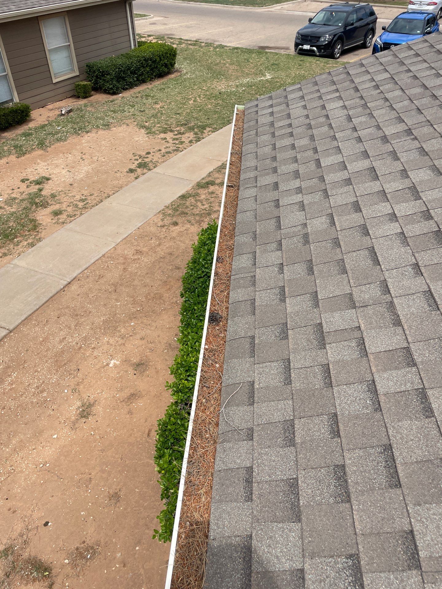 Commercial gutter cleaning Lubbock before photo with filled gutters