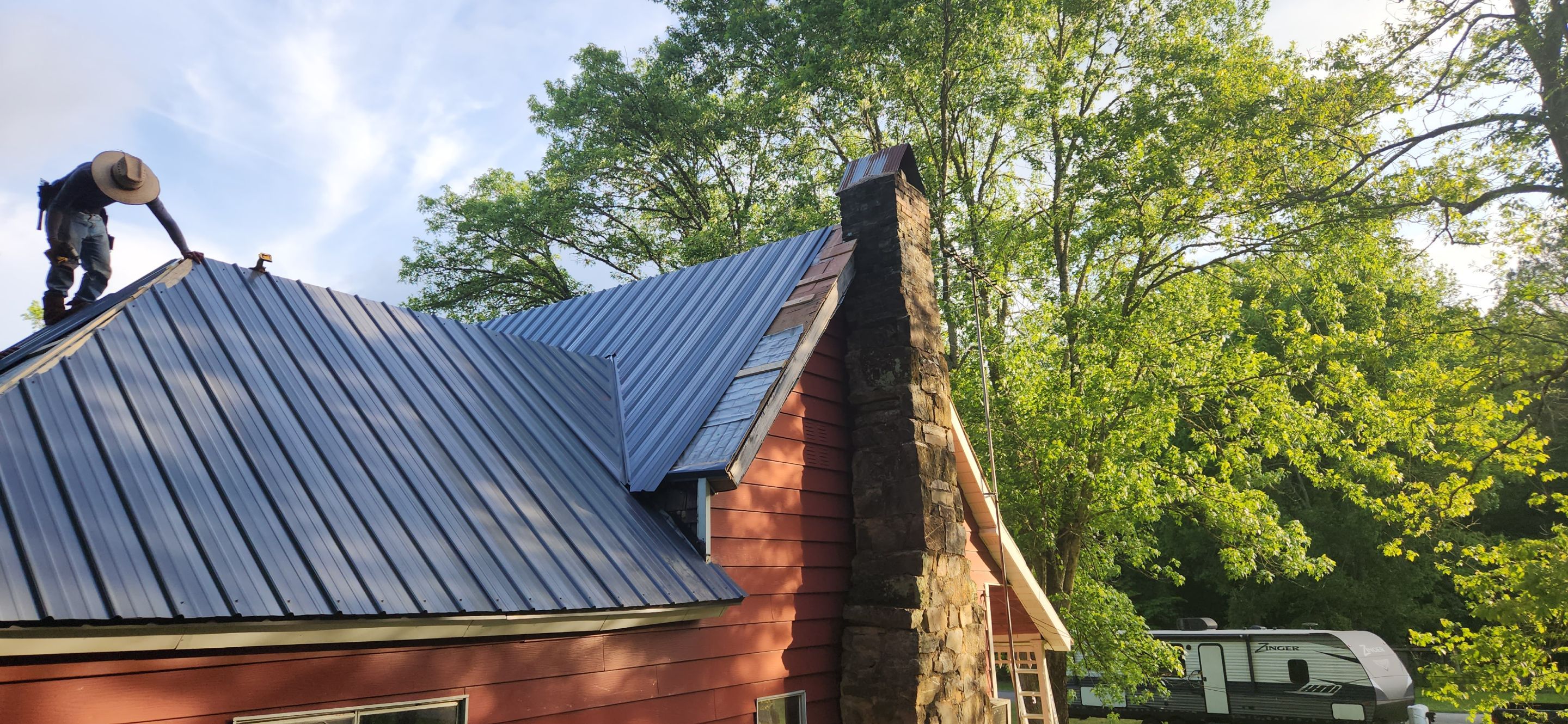 Residential Roofing Installation using 26 Gauge Colored Panels by Hostetler Roofing