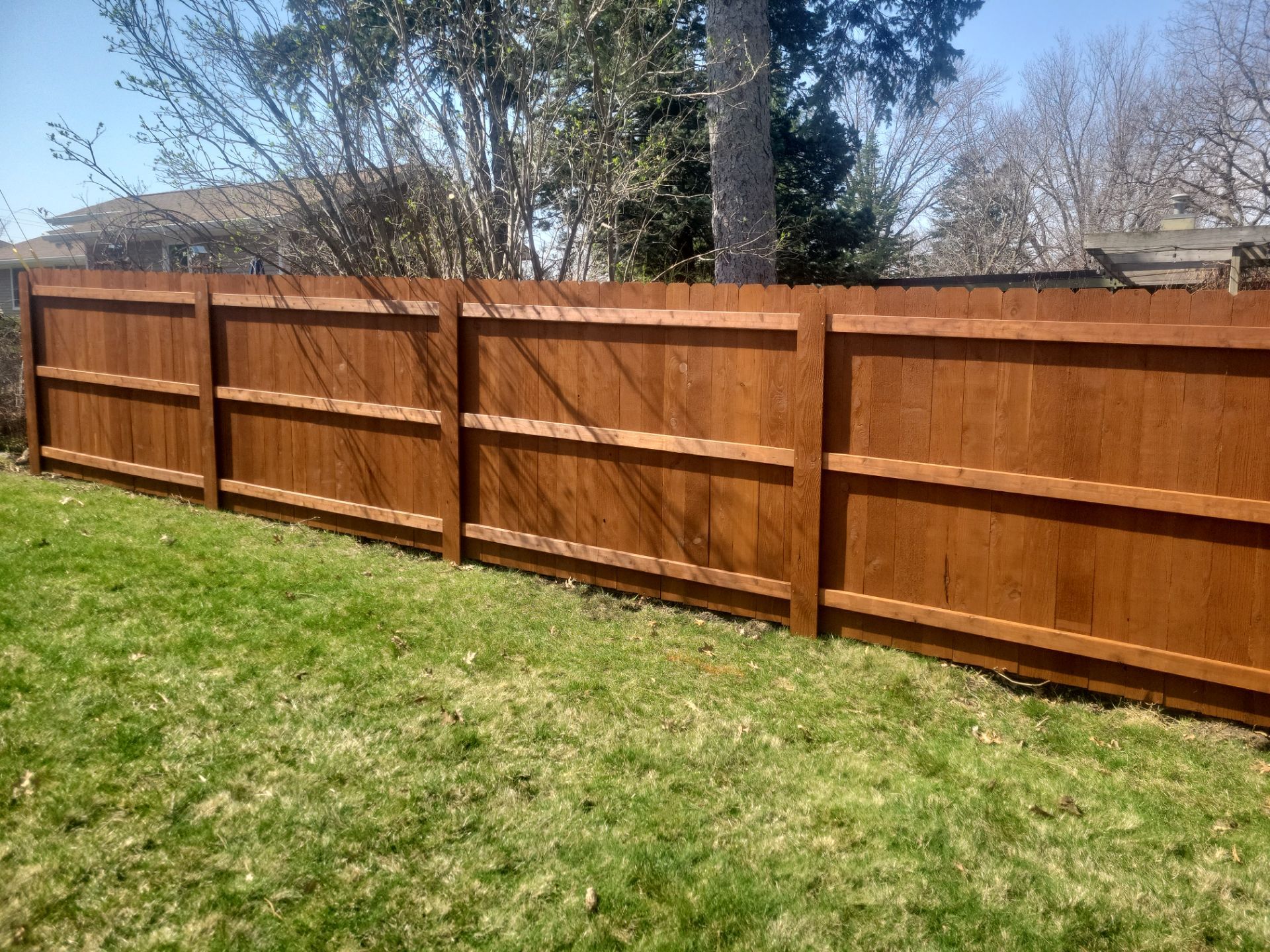 Stained Cedar Wood Privacy Fence Installation in Cedar Falls by Perfect Picket Fence and Stain