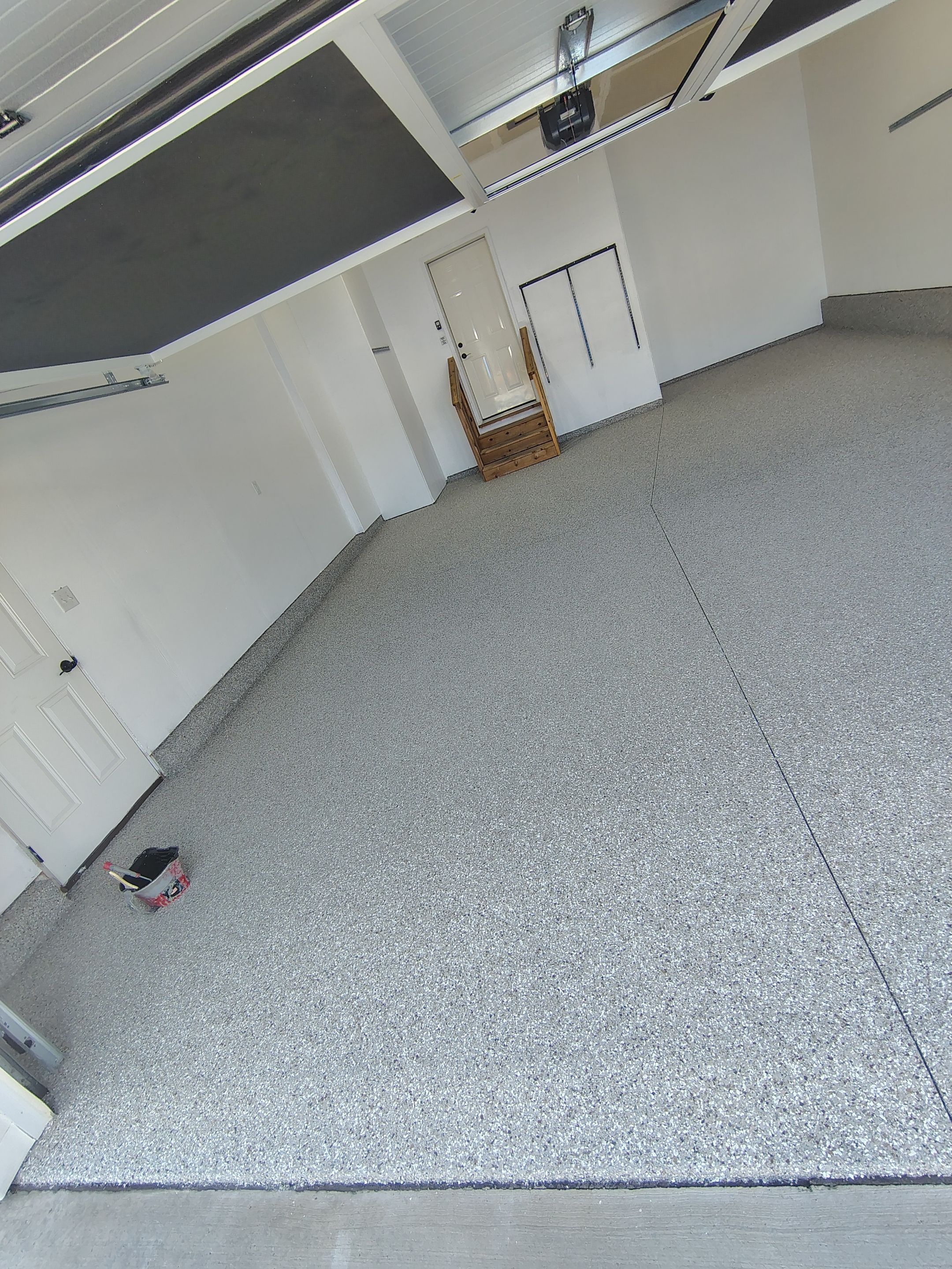 Sioux Falls Garage Floor Transformation With Gray Speckled Epoxy Coating by Select Painting, Coatings & Garage Cabinets