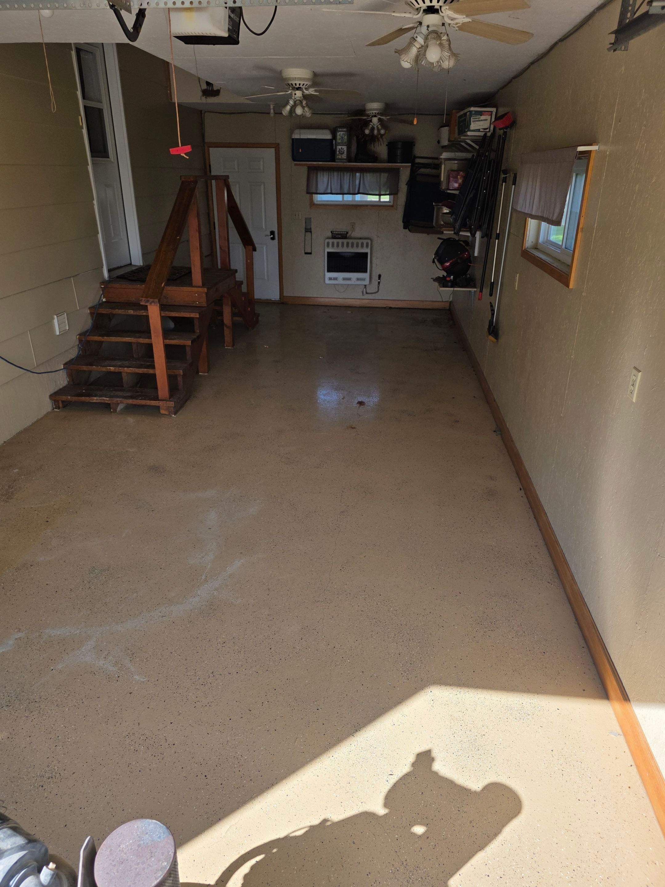 Full Garage and Basement Epoxy Floor Coating in Winner by Select Painting, Coatings & Garage Cabinets