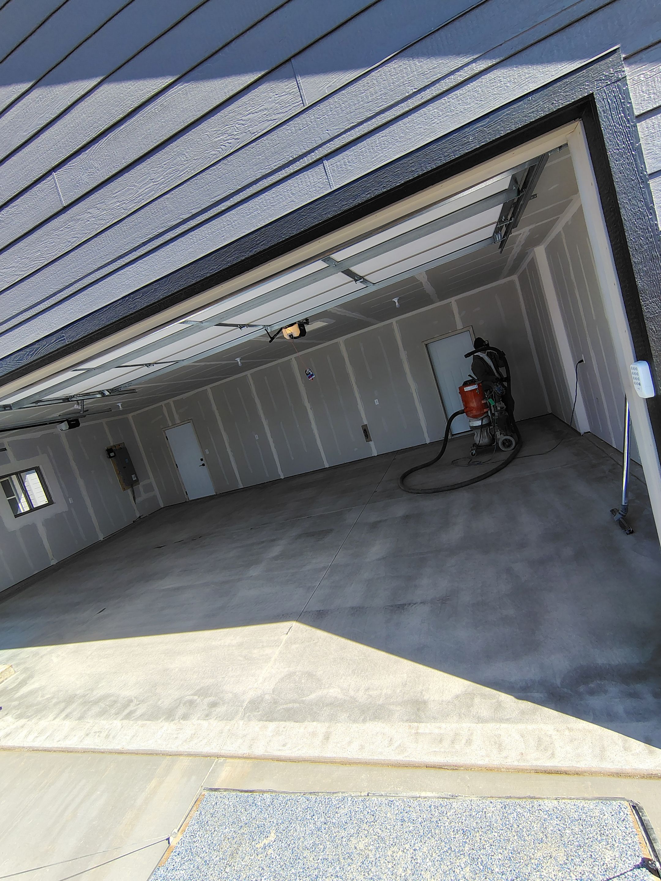 Speckled Epoxy Garage Floor Coating Installation in Sioux Falls by Select Painting, Coatings & Garage Cabinets