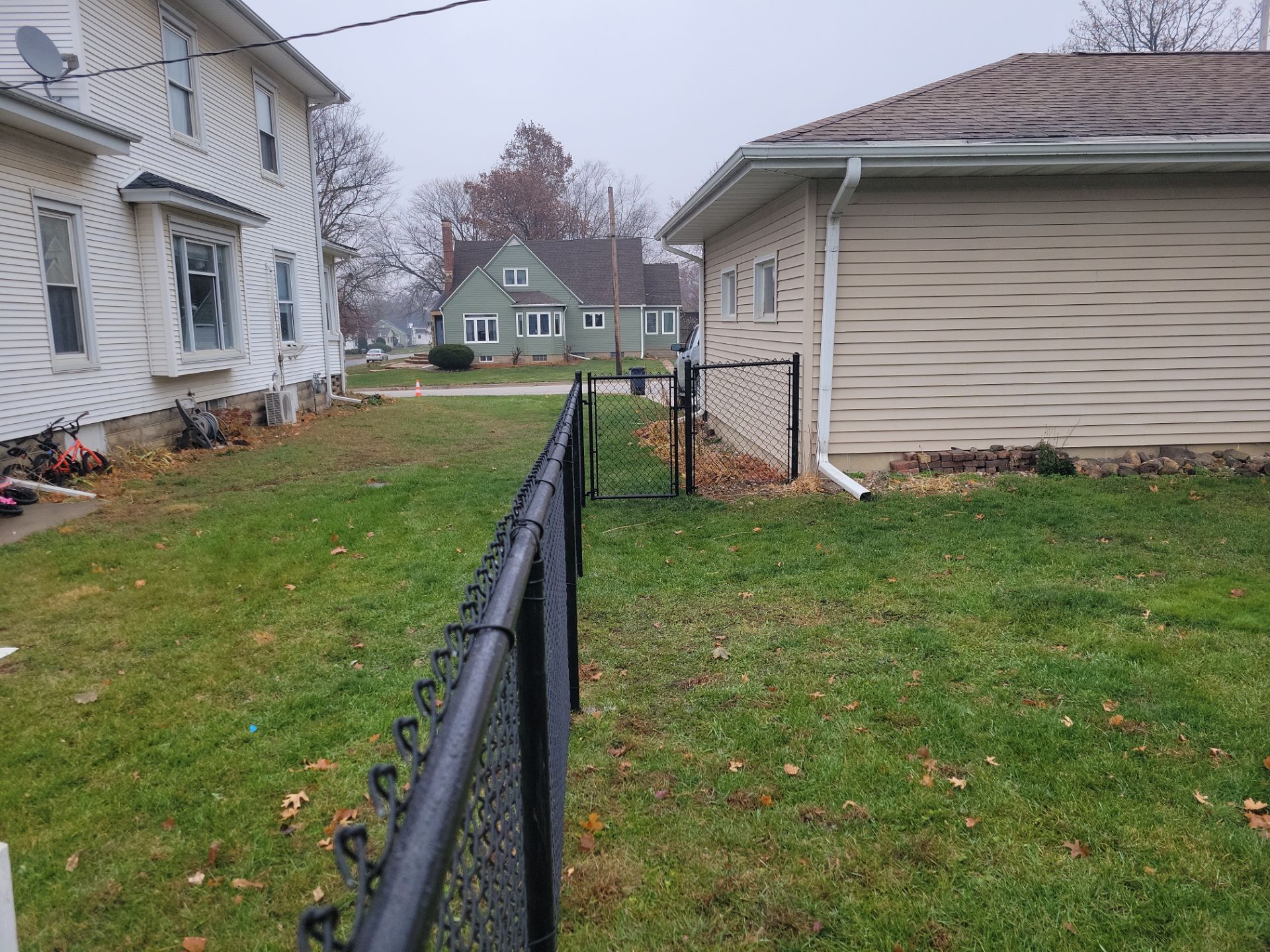 Black Vinyl-Coated Chain Link Fence Installation in Aplington by Perfect Picket Fence and Stain