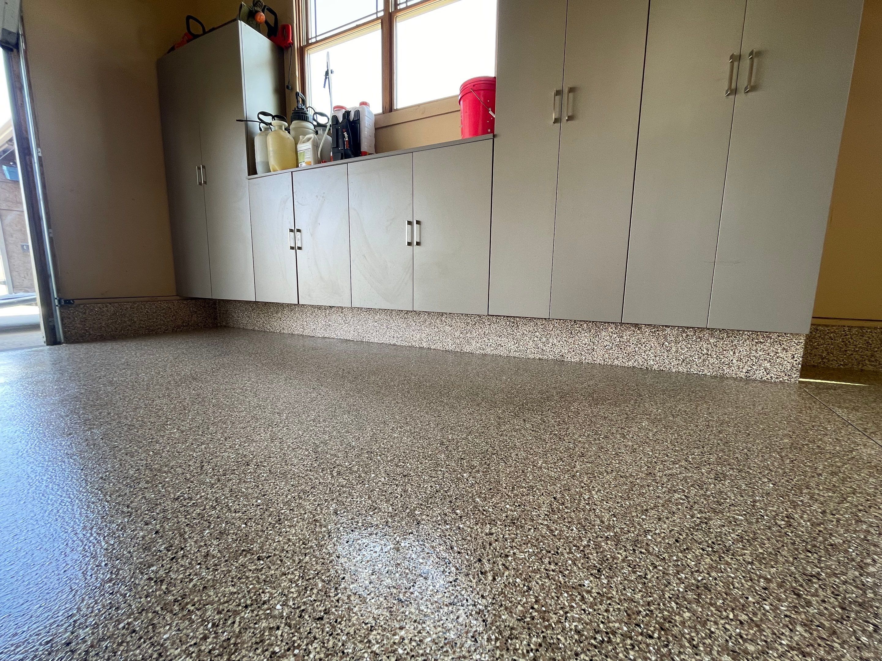 Residential Garage Floor Transformation with Speckled Epoxy Coating by Select Painting, Coatings & Garage Cabinets