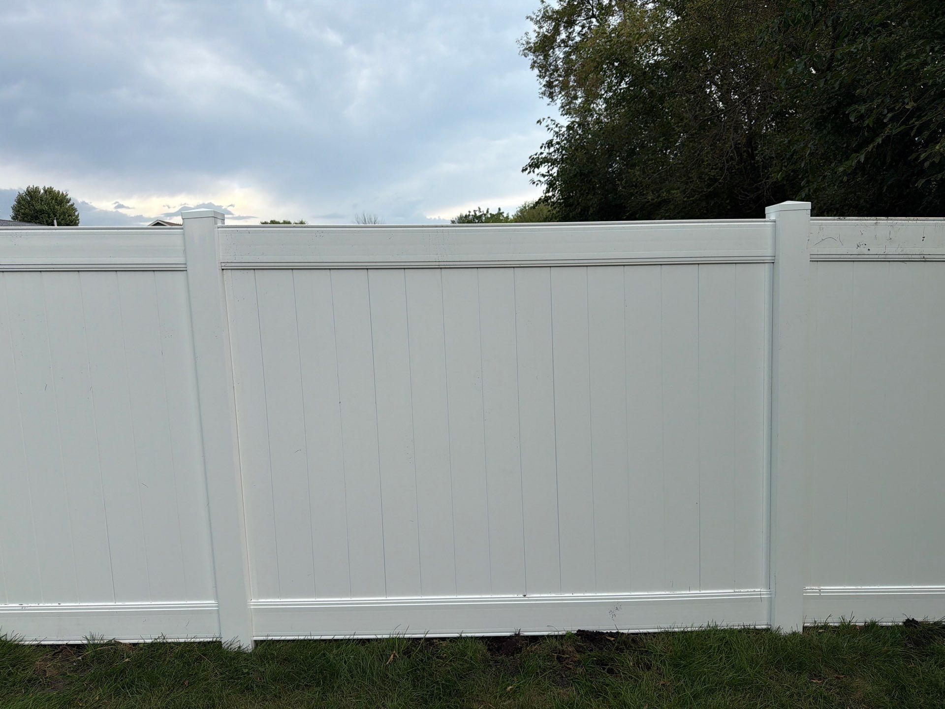 White Vinyl Privacy Fence Installation in Raymond, IA by Perfect Picket Fence and Stain