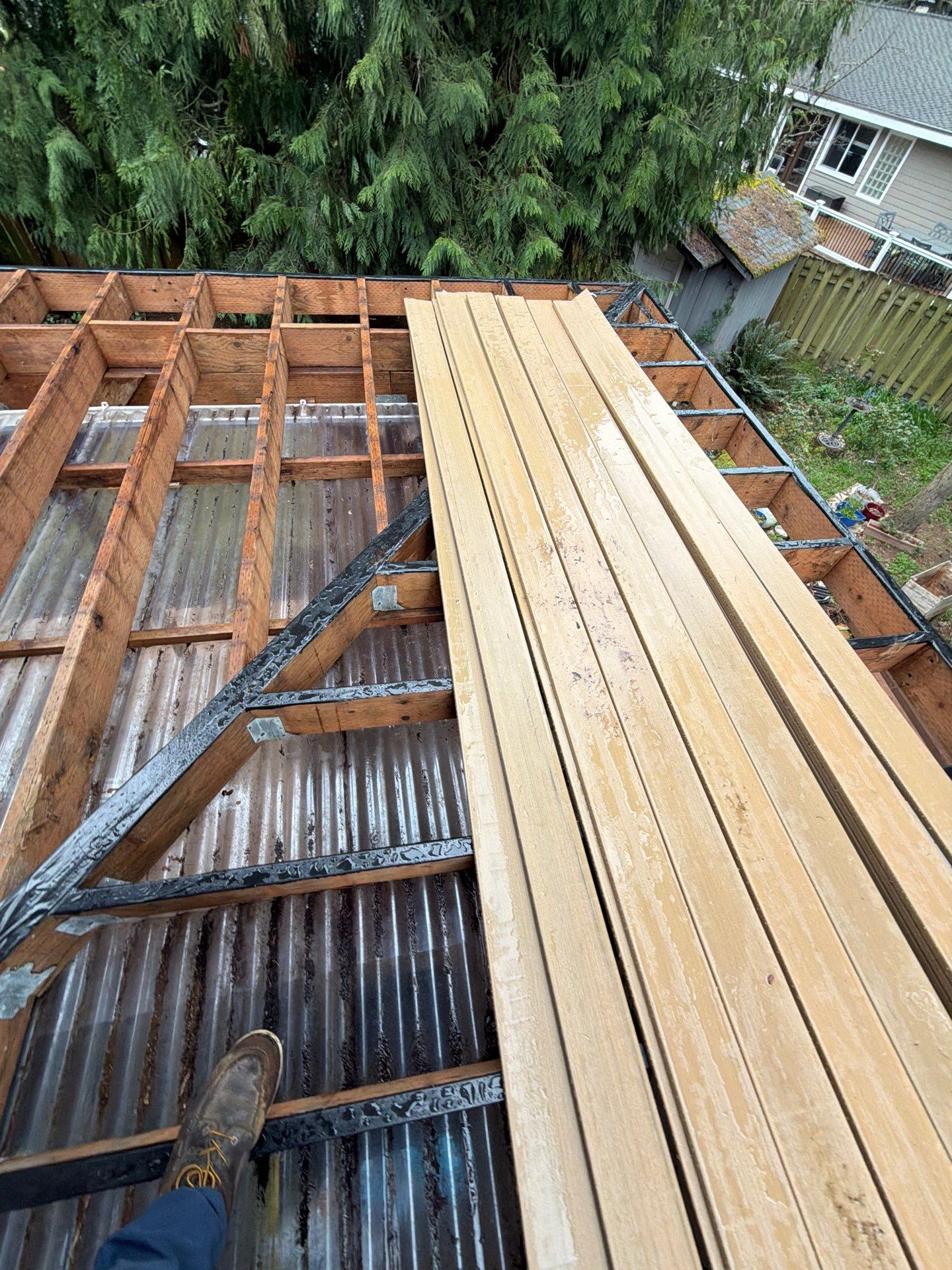 Elevated TimberTech Composite Deck Replacement With Black Metal Railings by Emerald City Energy