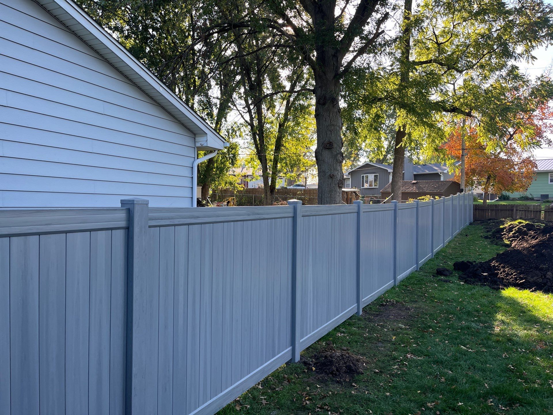 Chai Gray Vinyl Privacy Fence and Gate Installation in Cedar Falls by Perfect Picket Fence and Stain