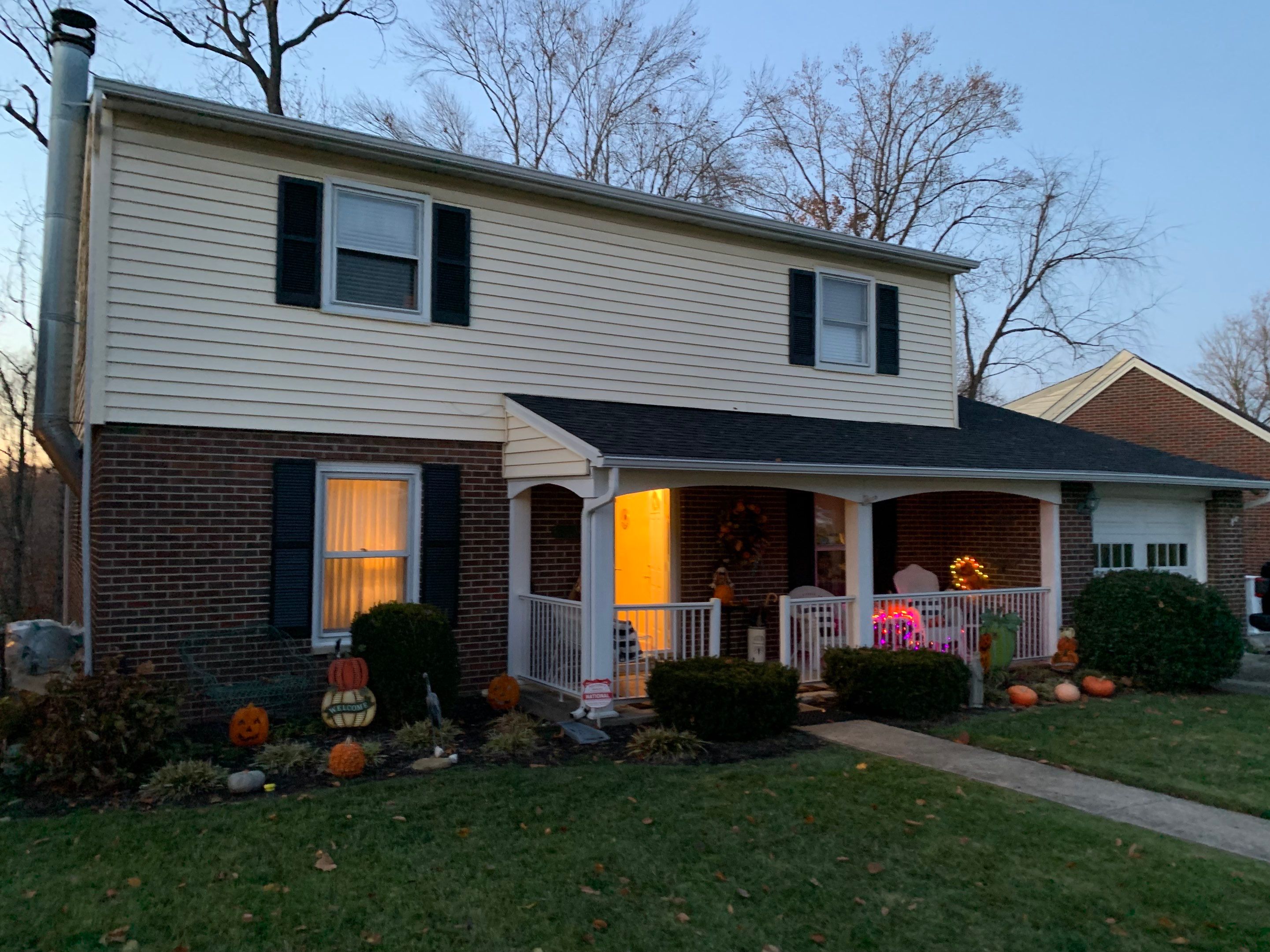 Replace dated vinyl siding with new white exterior Portfolio vinyl siding  by Secure Construction Company Inc
