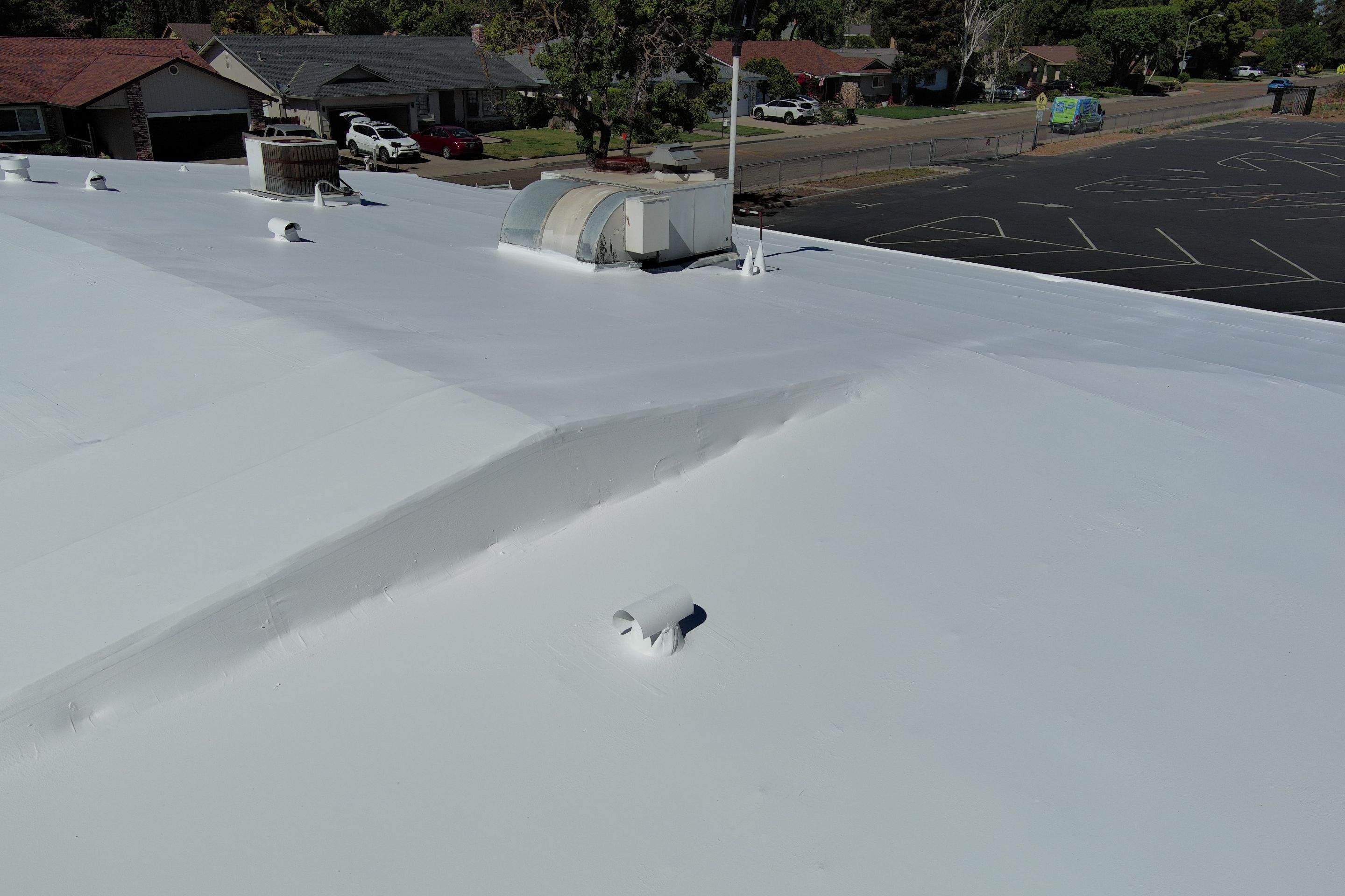 Single-ply restoration system using Benchmark/PUMA XL coatings over TPO single-ply roofing by Straight Edge Roofing Inc