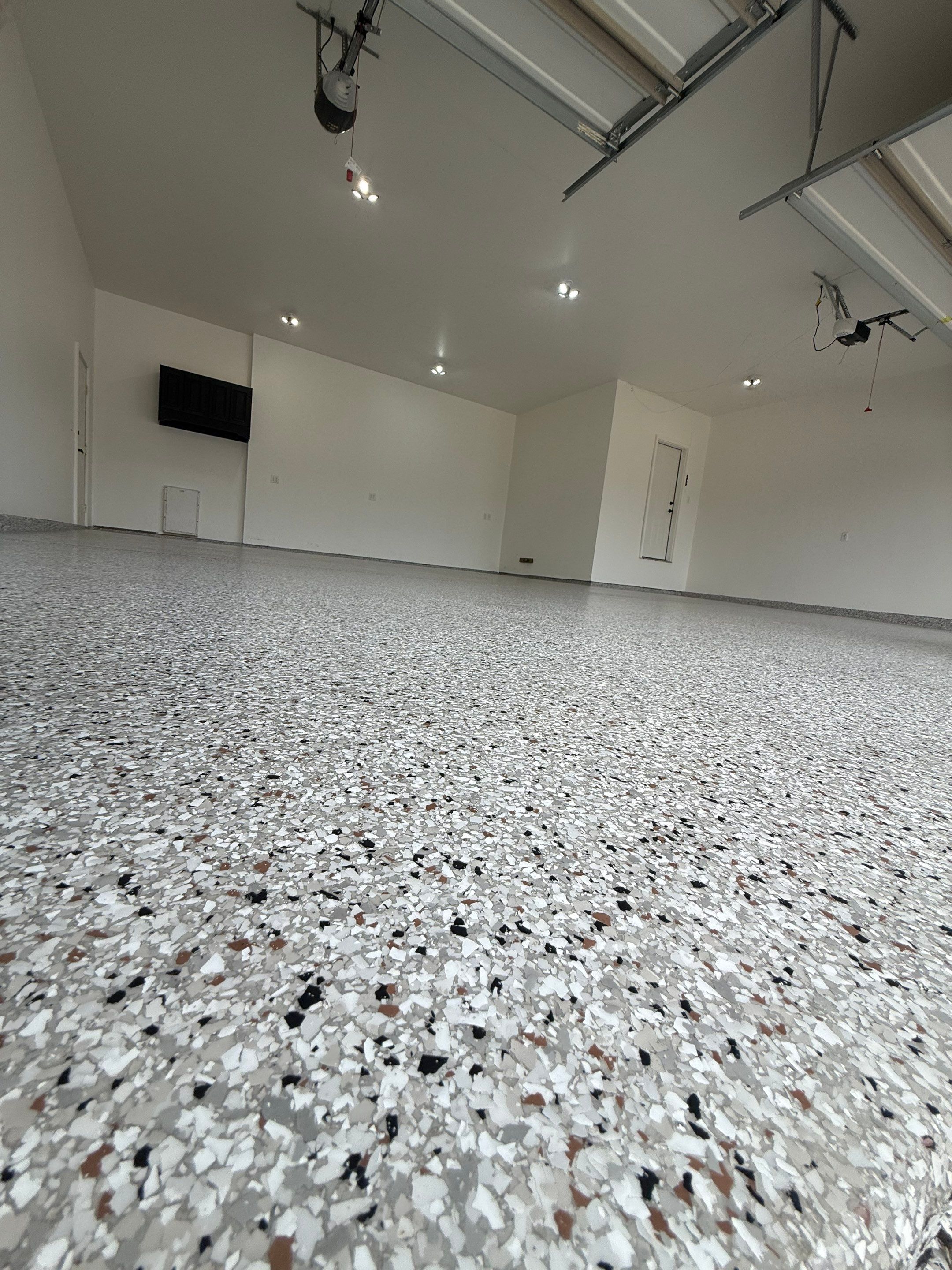 Full Garage Floor Resurfacing and Decorative Epoxy Flake Finish by Select Painting, Coatings & Garage Cabinets