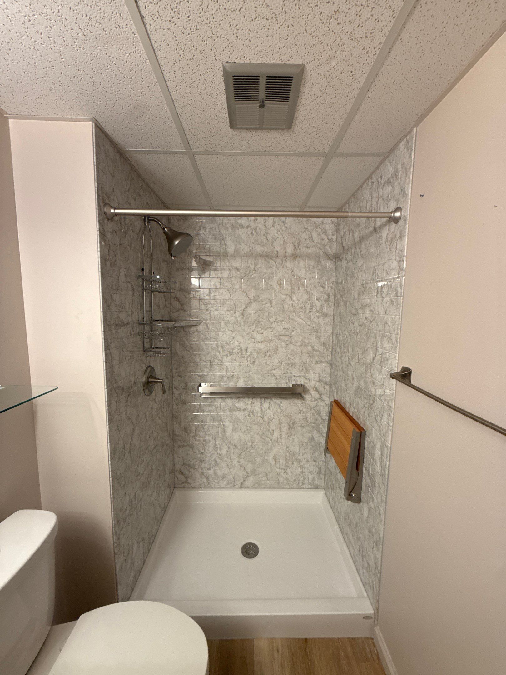 Jacuzzi Walk-In Shower Installation with Marble Accents in Traverse City by Rainbow Seamless Systems
