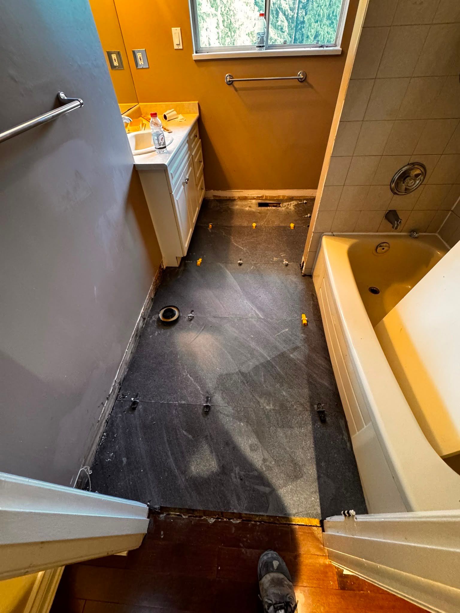 Bathroom Tile Floor Upgrade After Toilet Leak – West Vancouver Rental Property by YVR Construction Group