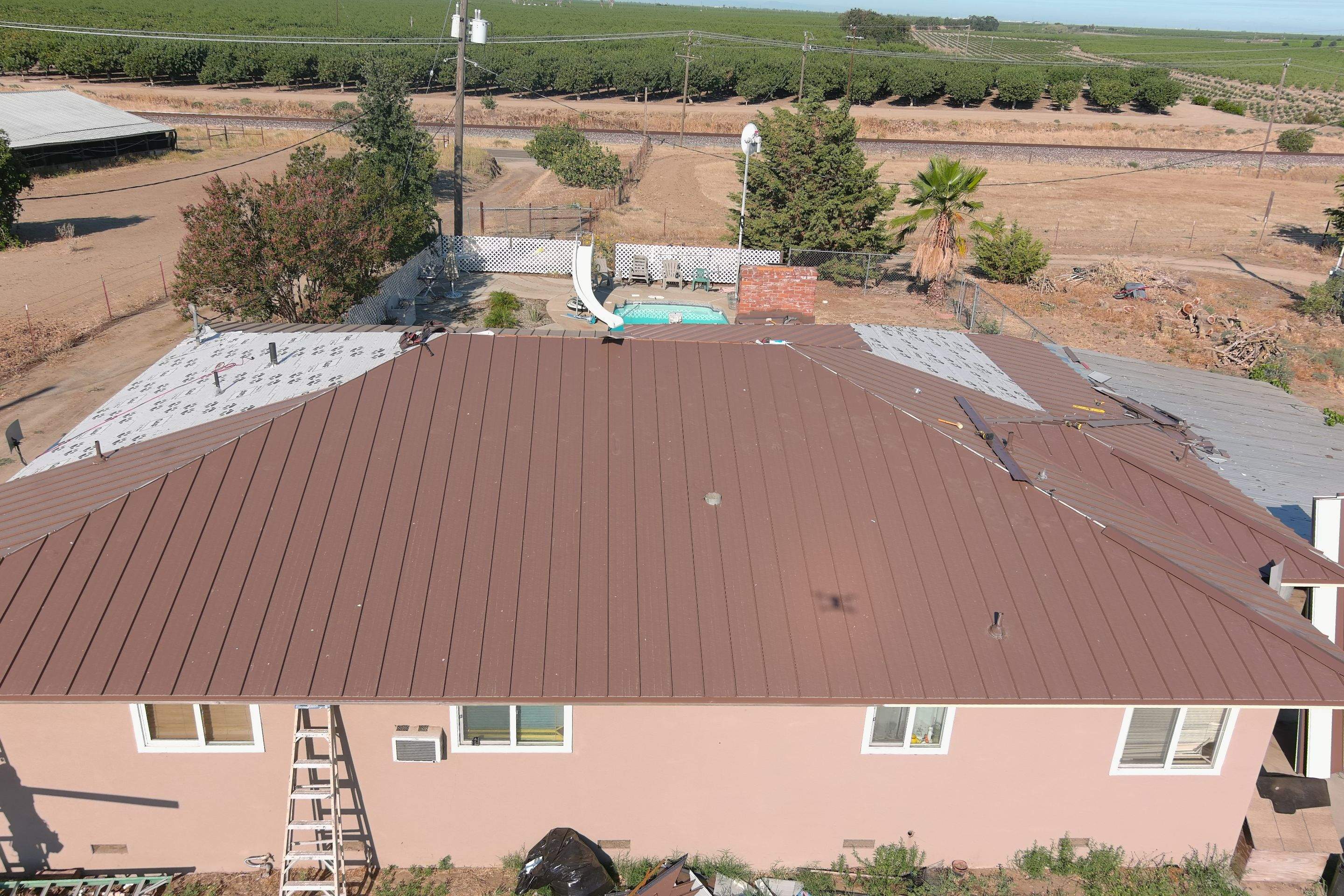 Metal roofing installation using Standing seam metal roofing system by Straight Edge Roofing Inc