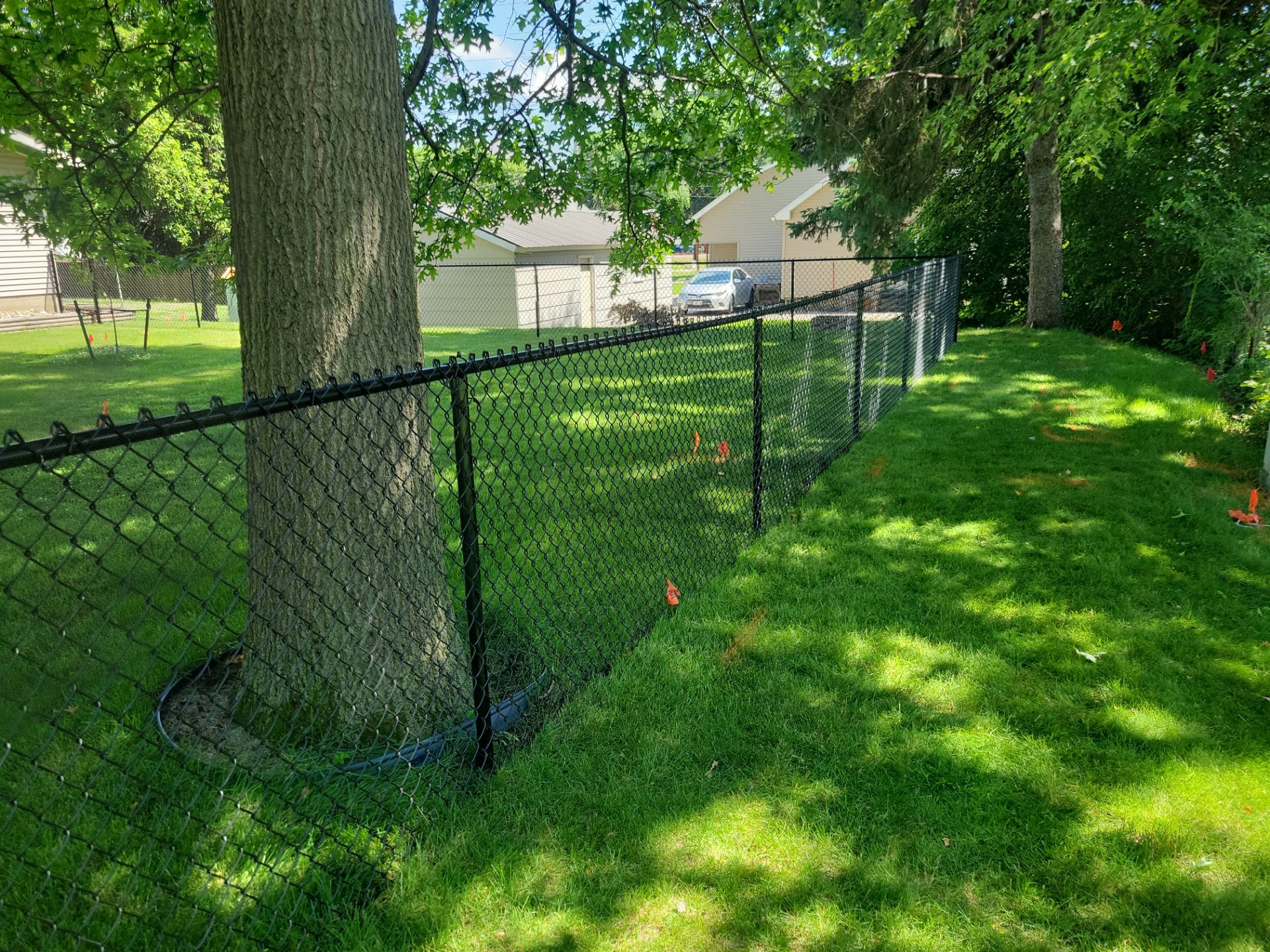 Black Chain Link Perimeter Fence and Driveway Gate in Waverly by Perfect Picket Fence and Stain