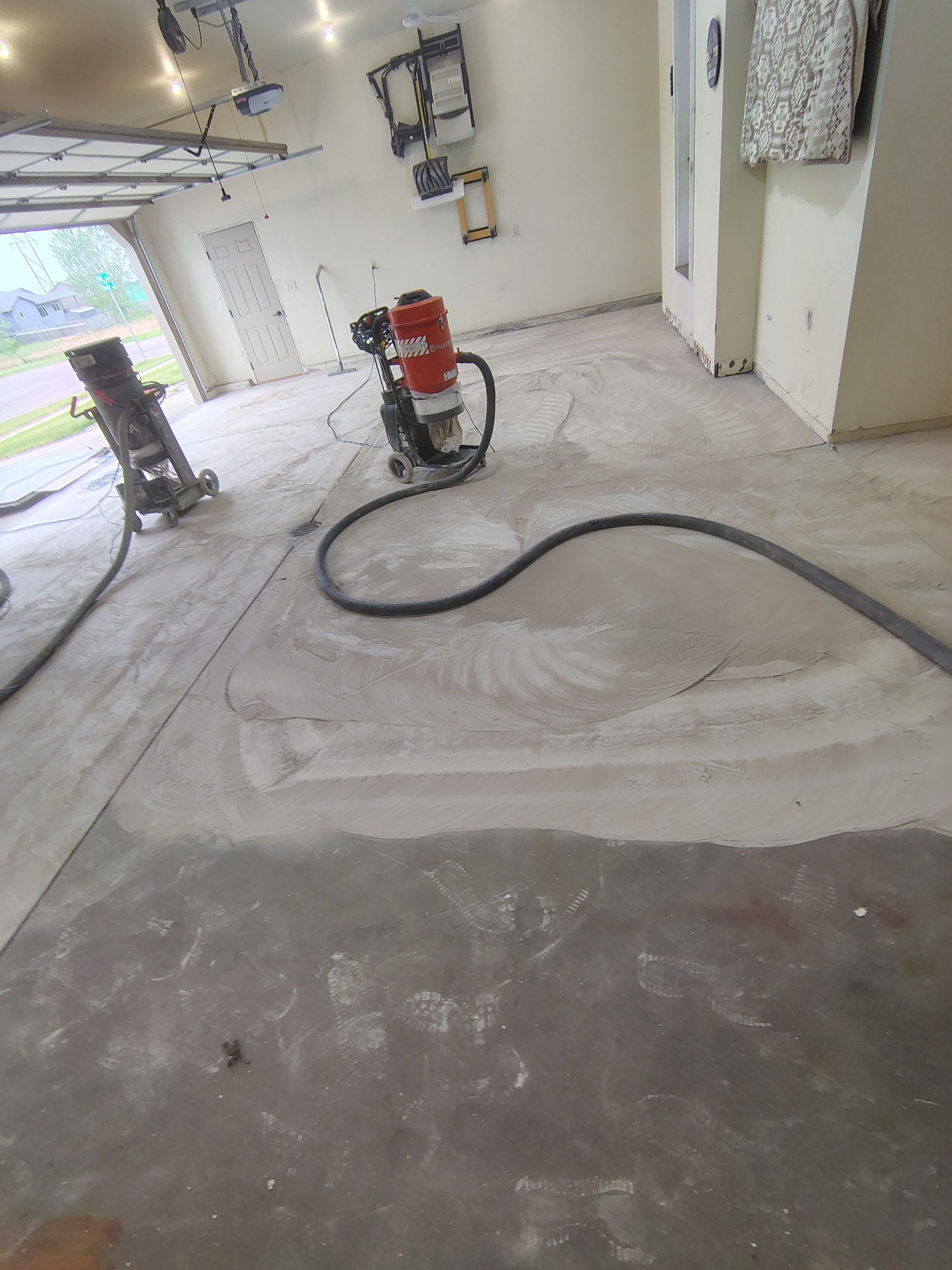 Sioux Falls Garage Floor Repair and Speckled Epoxy Coating Installation by Select Painting, Coatings & Garage Cabinets