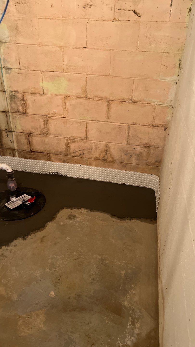 Interior drain tile system installation by ACE Waterproofing & Basement Solutions
