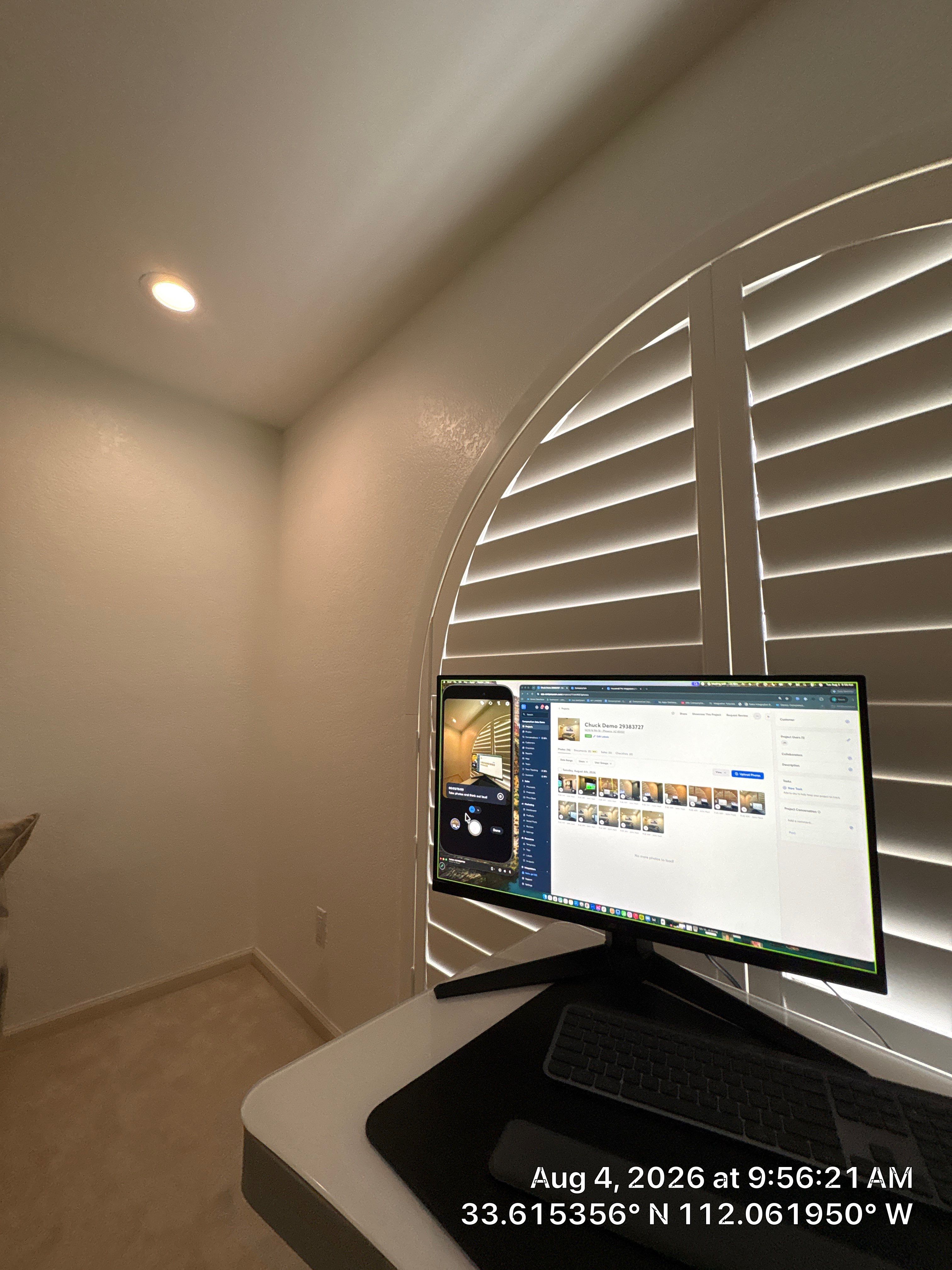 Custom Home Office Setup Featuring Arched Plantation Shutters and Accent Wall by CompanyCam Sales Demo