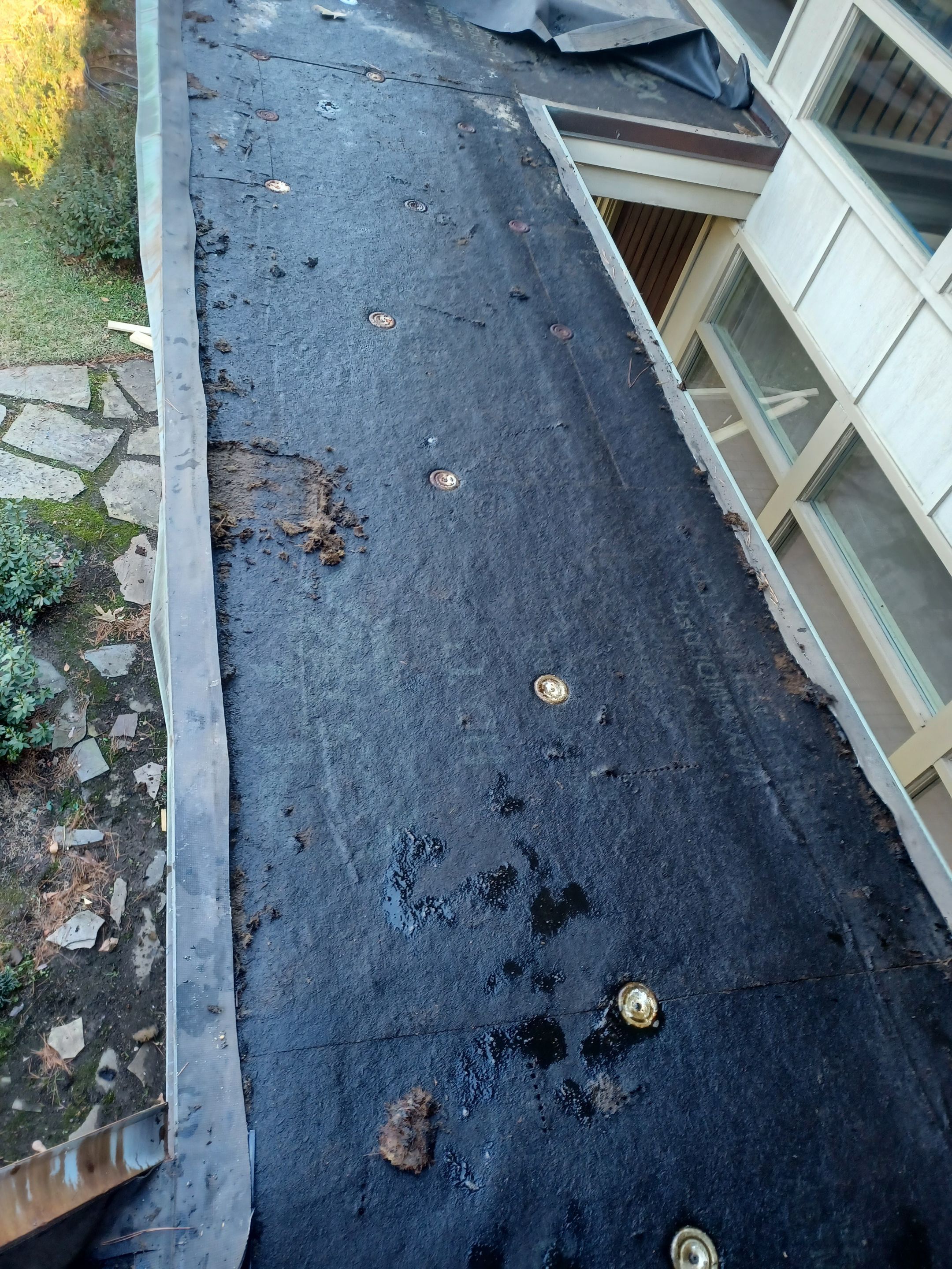 Residential Roofing Installation using PVC membrane and 24 gauge Standing Seam Metal by Hostetler Roofing