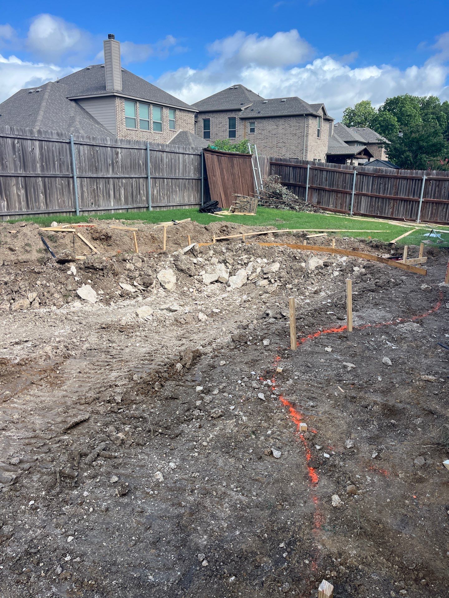 Freeform Pool with Tanning Ledge and Raised Stone Wall by Pinnacle Pools and Spas - DFW