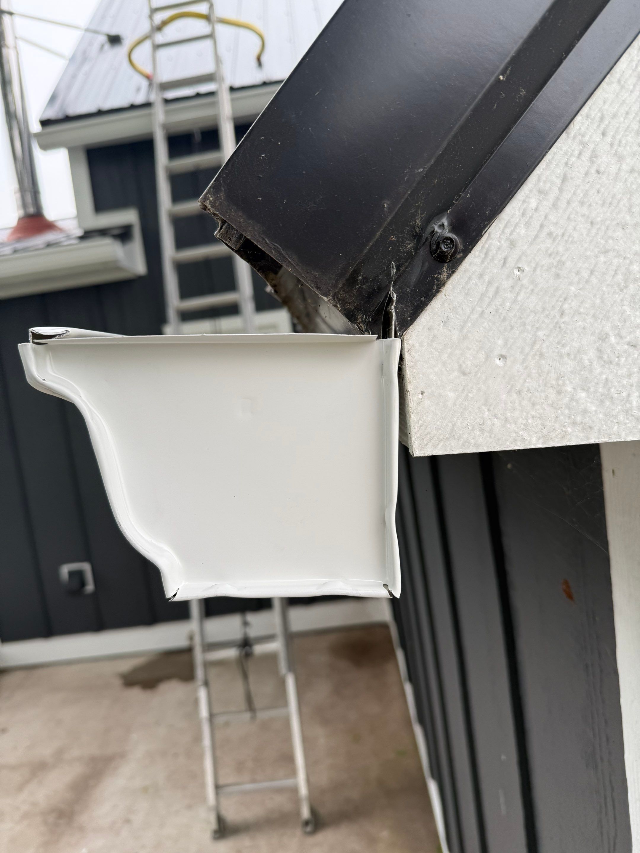 Seamless Gutter and Gutter Helmet Installation on Bellaire Metal Roof by Rainbow Seamless Systems