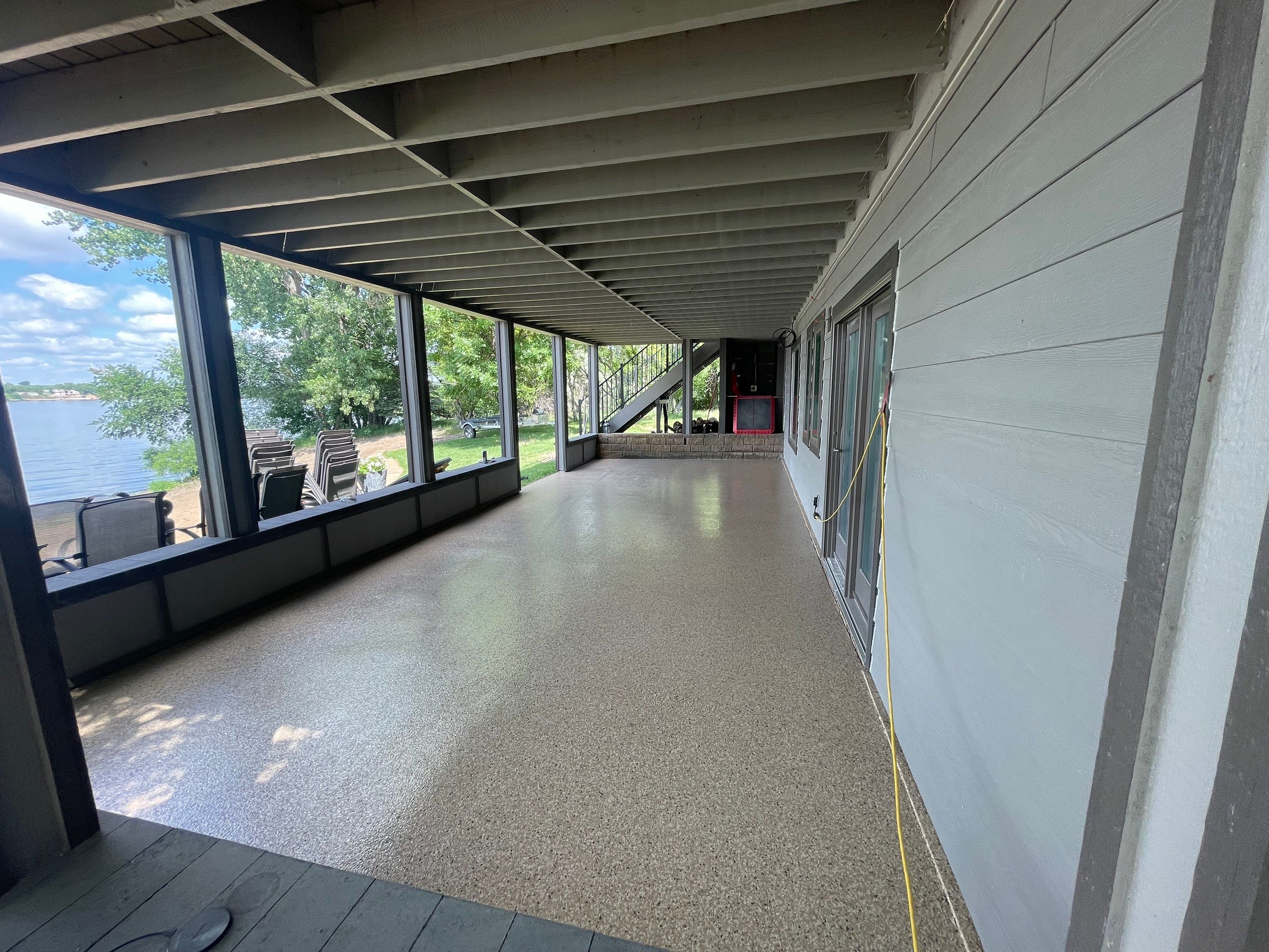Lakefront Screened Patio Concrete Coating Installation in Wentworth by Select Painting, Coatings & Garage Cabinets
