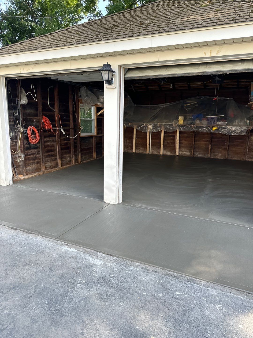 Concrete garage floor replacement with a broom finished apron by NG Masonry & Construction LLC