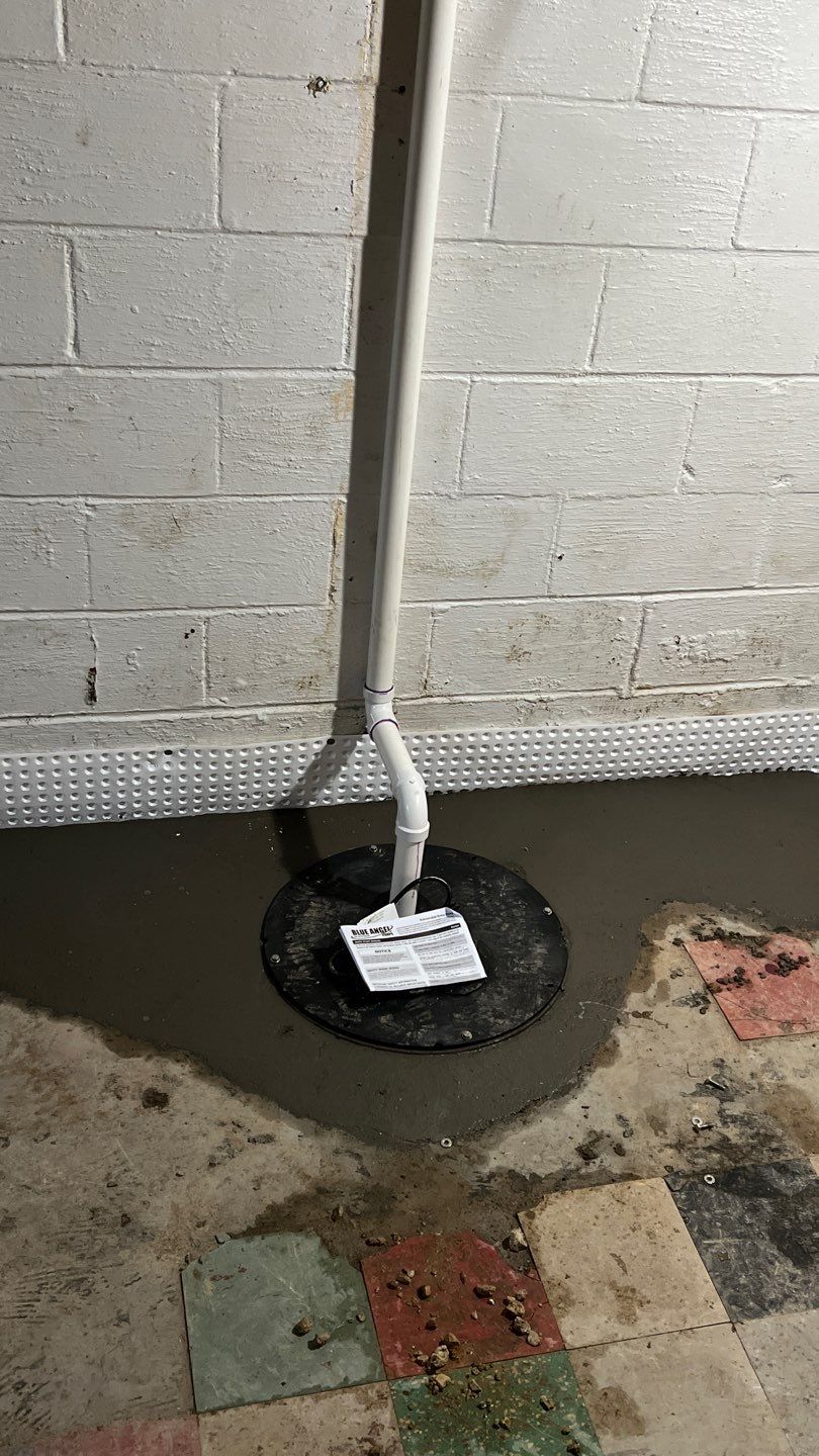 Interior drain tile system installation by ACE Waterproofing & Basement Solutions